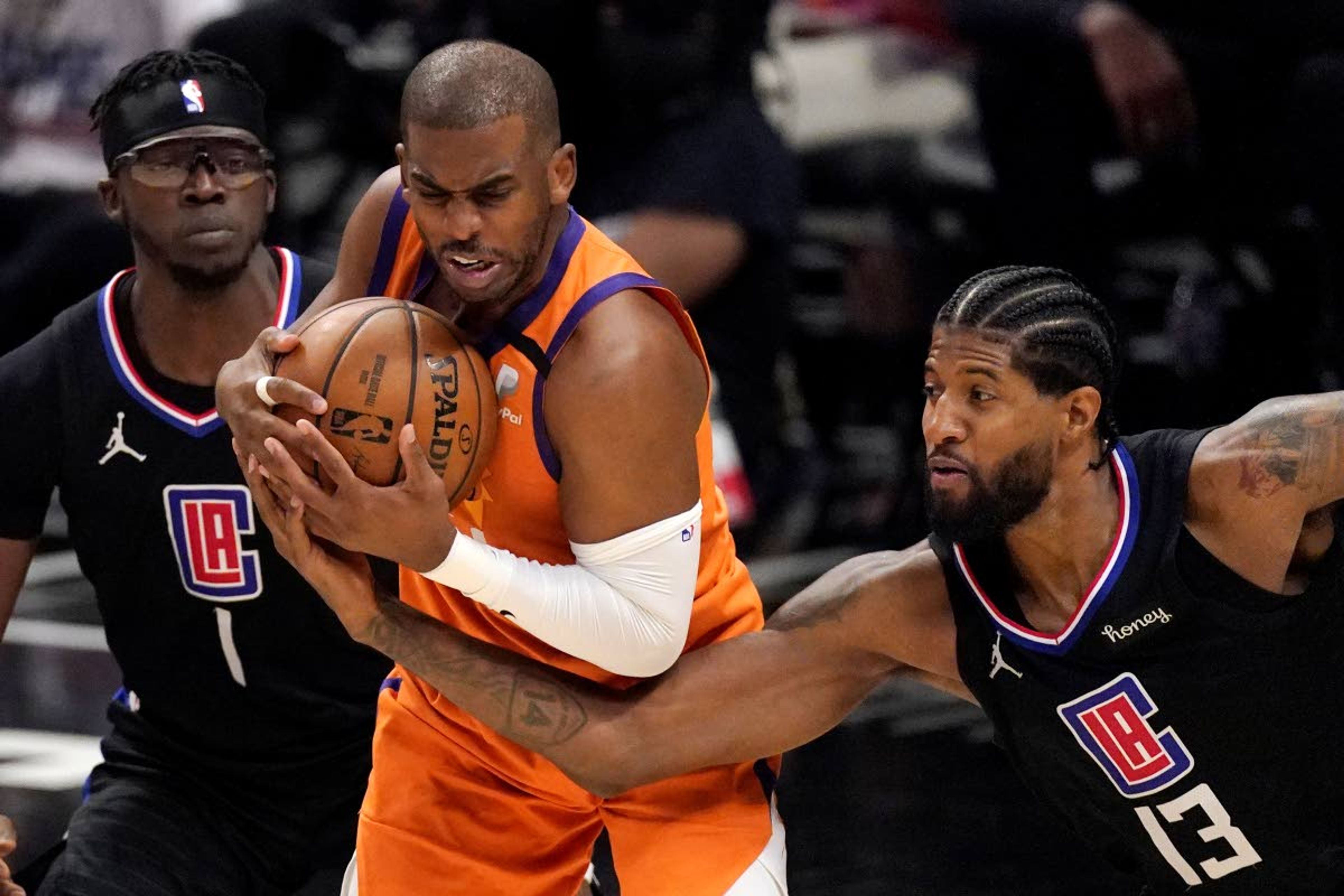 Associated PressClippers guard Paul George, right, reaches in on Suns guard Chris Paul during the second half in Game 6 of the NBA Western Conference finals Wednesday in Los Angeles.