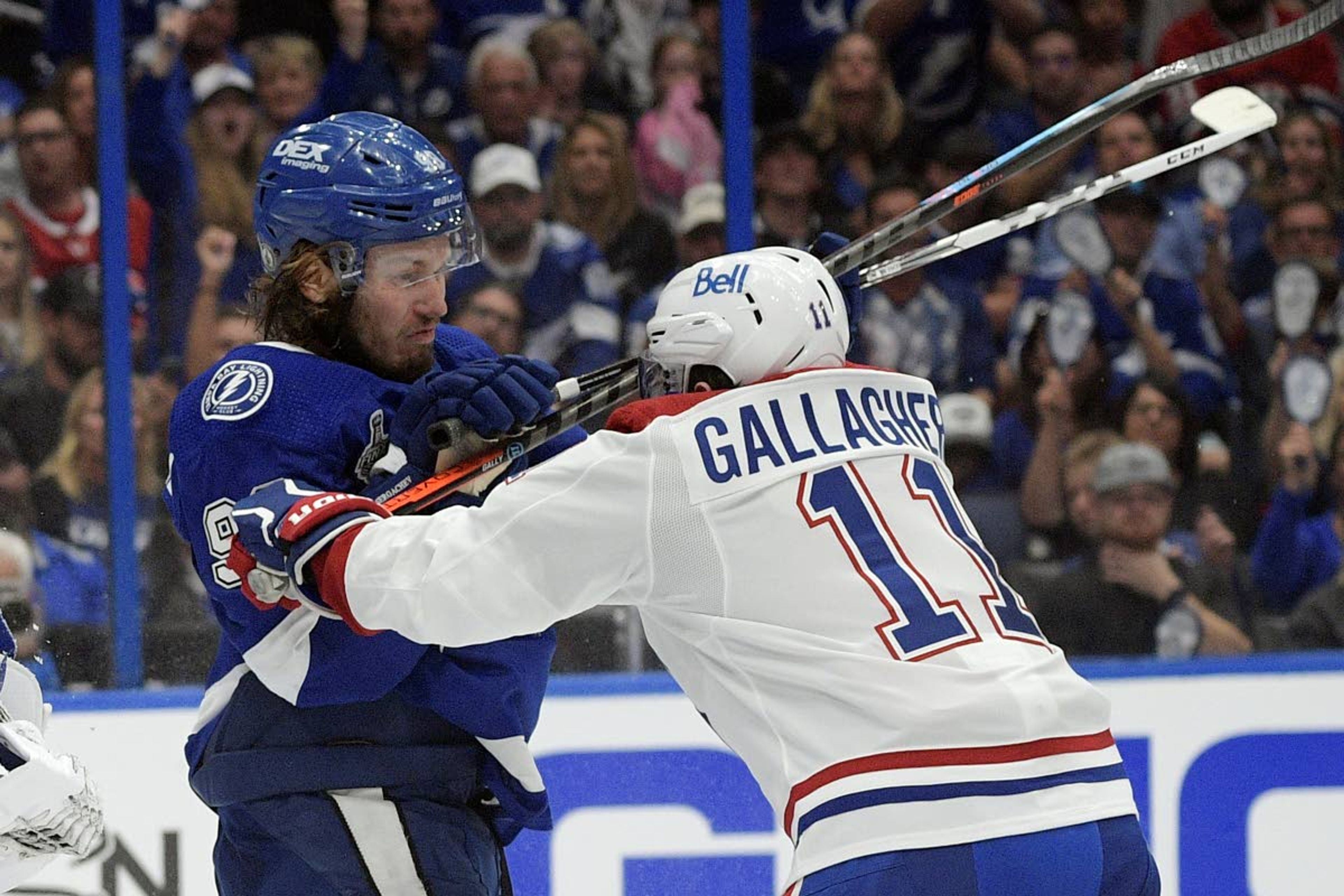 Tampa Bay Lightning defenseman Mikhail Sergachev checks Montreal Canadiens right wing Brendan Gallagher (11) during the third period in Game 1 of the NHL hockey Stanley Cup finals, Monday, June 28, 2021, in Tampa, Fla. (AP Photo/Phelan Ebenhack)