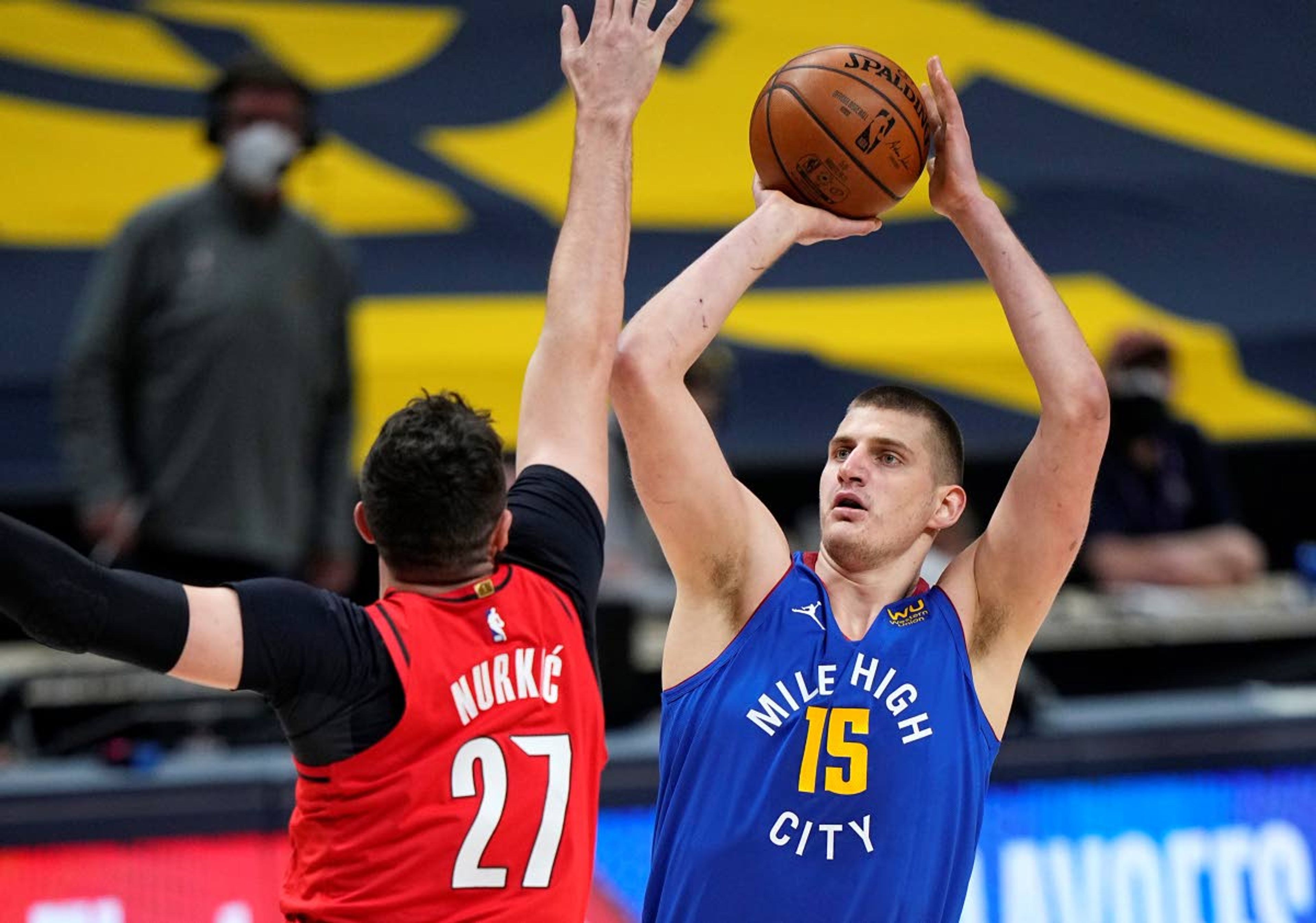 Denver Nuggets center Nikola Jokic (15) shoots against Portland Trail Blazers center Jusuf Nurkic (27) during the first half of Game 5 of a first-round NBA basketball playoff series Tuesday, June 1, 2021, in Denver. (AP Photo/Jack Dempsey)