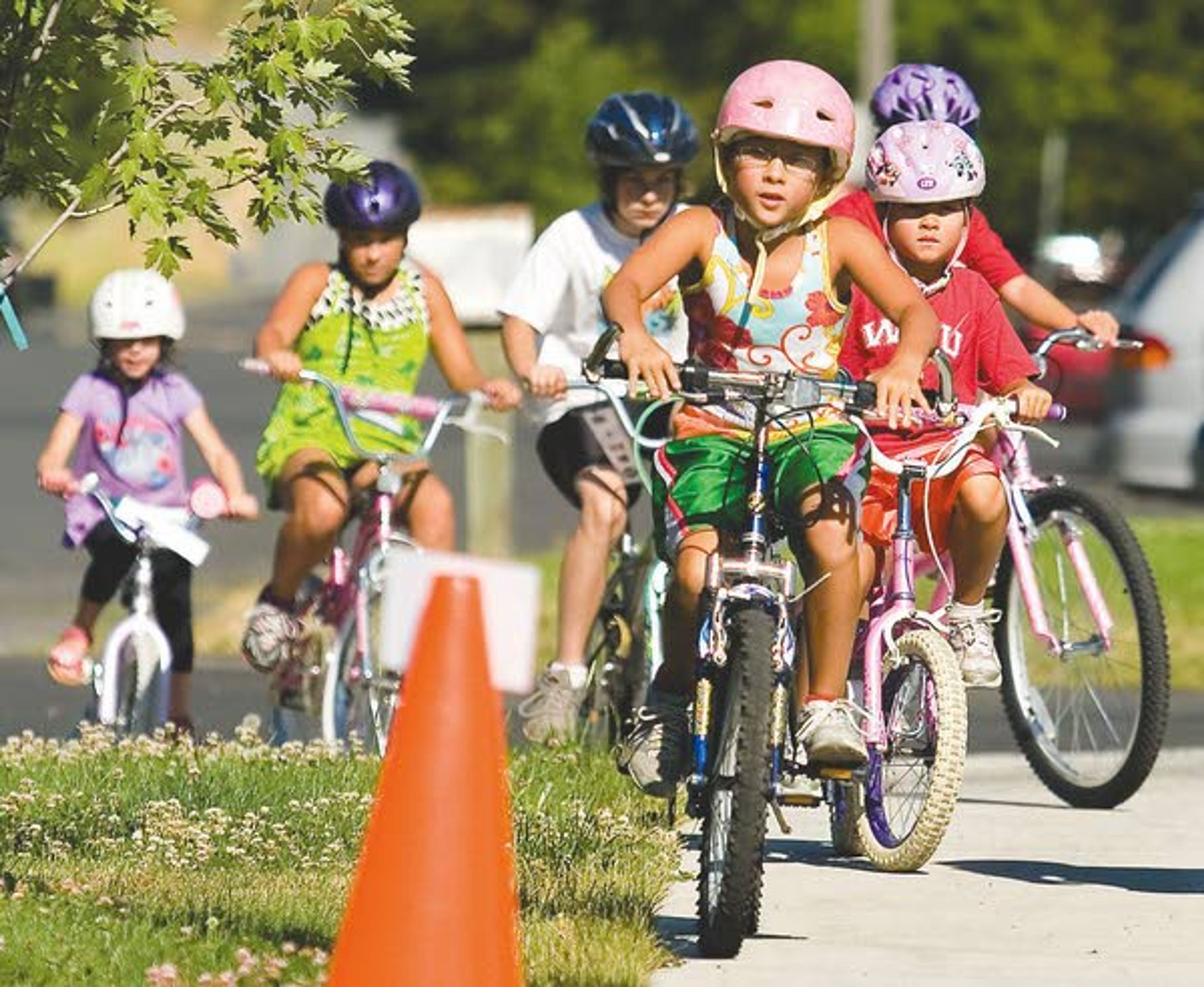 Children ride in the Gritman Therapy Solutions bike group in Moscow on Tuesday.