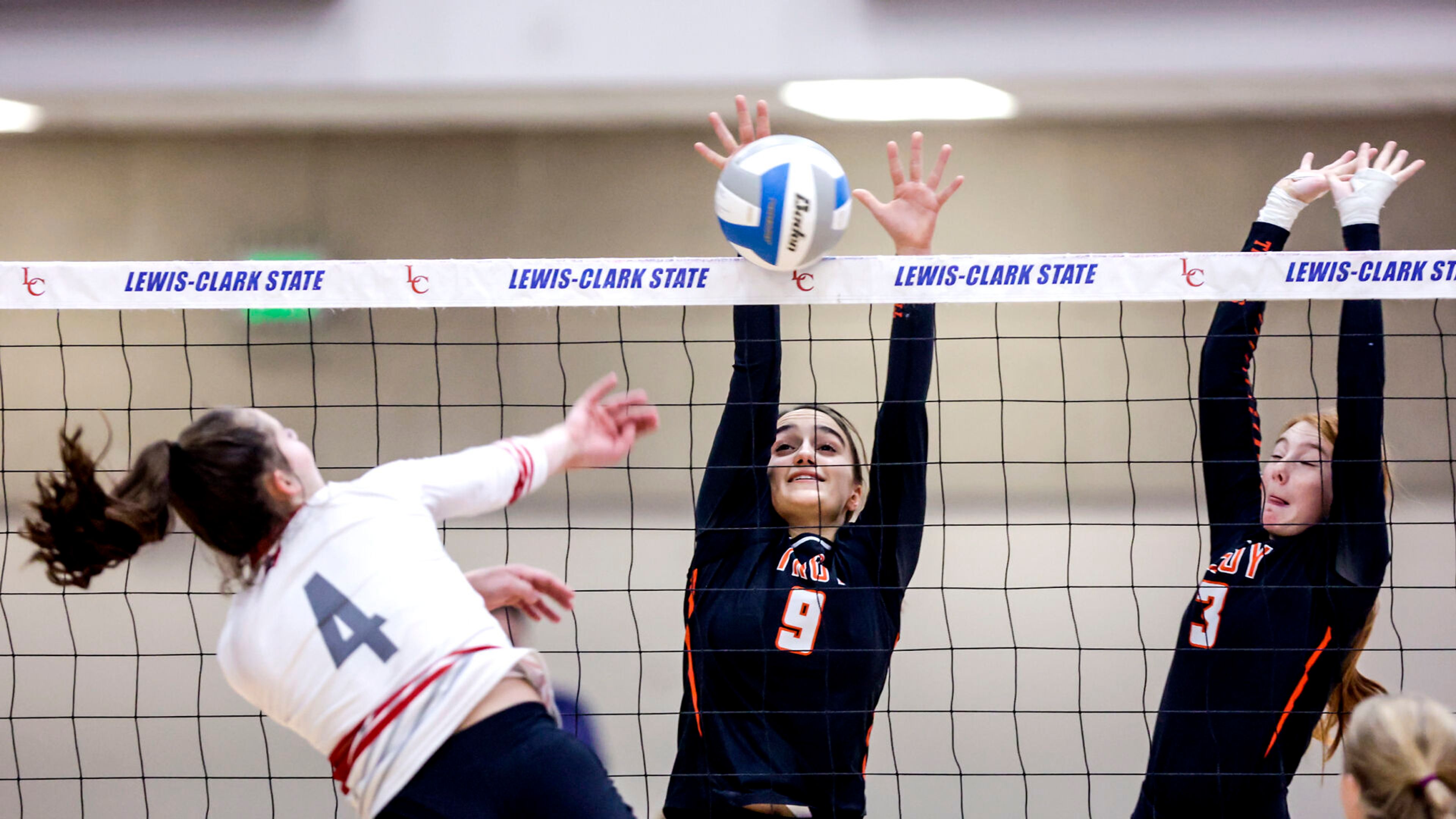 Troy setter Isabelle Raasch manages to block a shot from Grace rightside hitter Kylie Hulse at the Lewis-Clark State College Athletic Center on Saturday. Troy defeated Grace in three sets to become the 1A DI state champions.