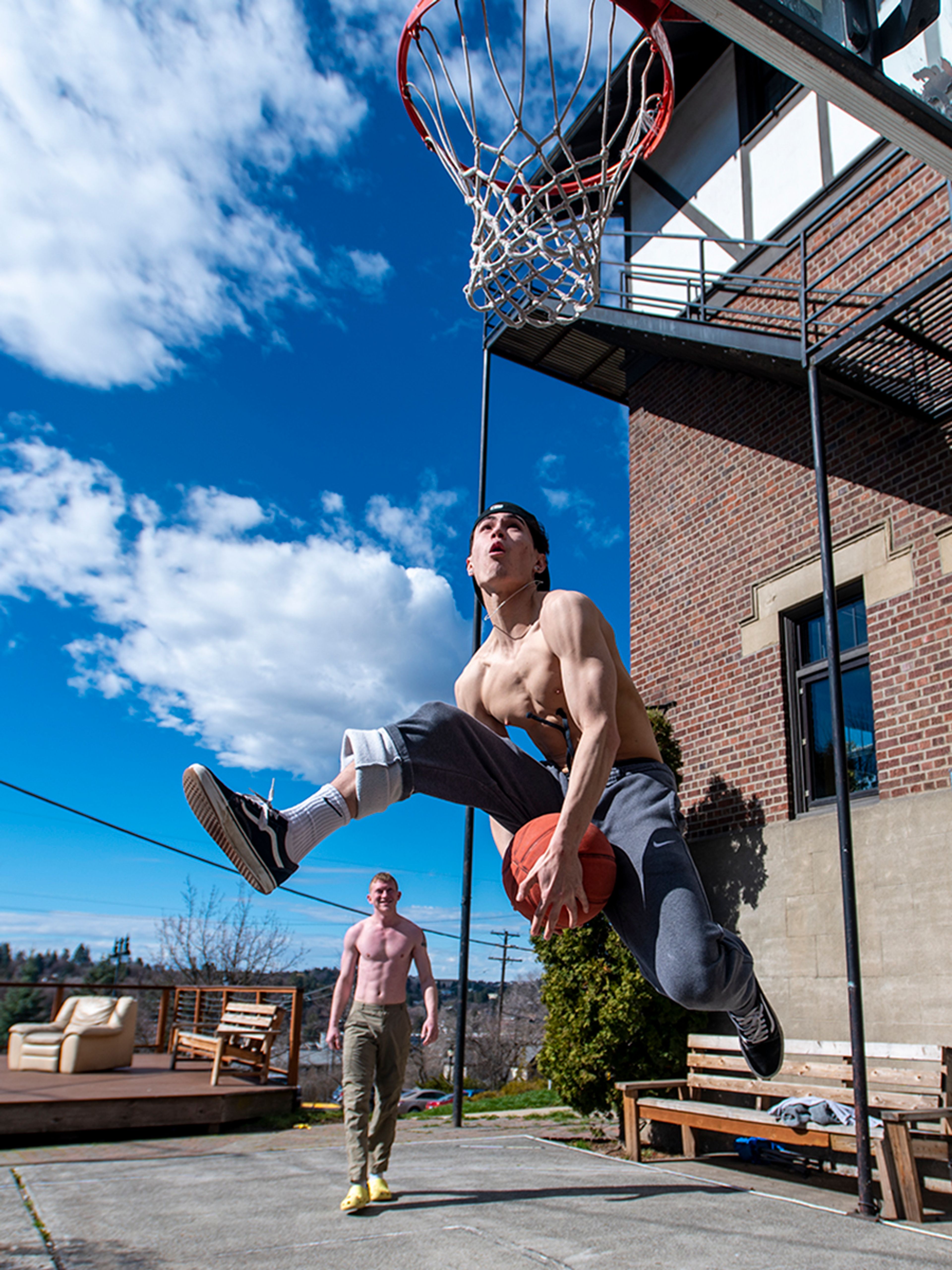 Cole Hamilton, front, attempts to go between his legs while having a dunk contest with Jake Rotter at Washington State University’s Delta Tau Delta fraternity Wednesday afternoon in Pullman.