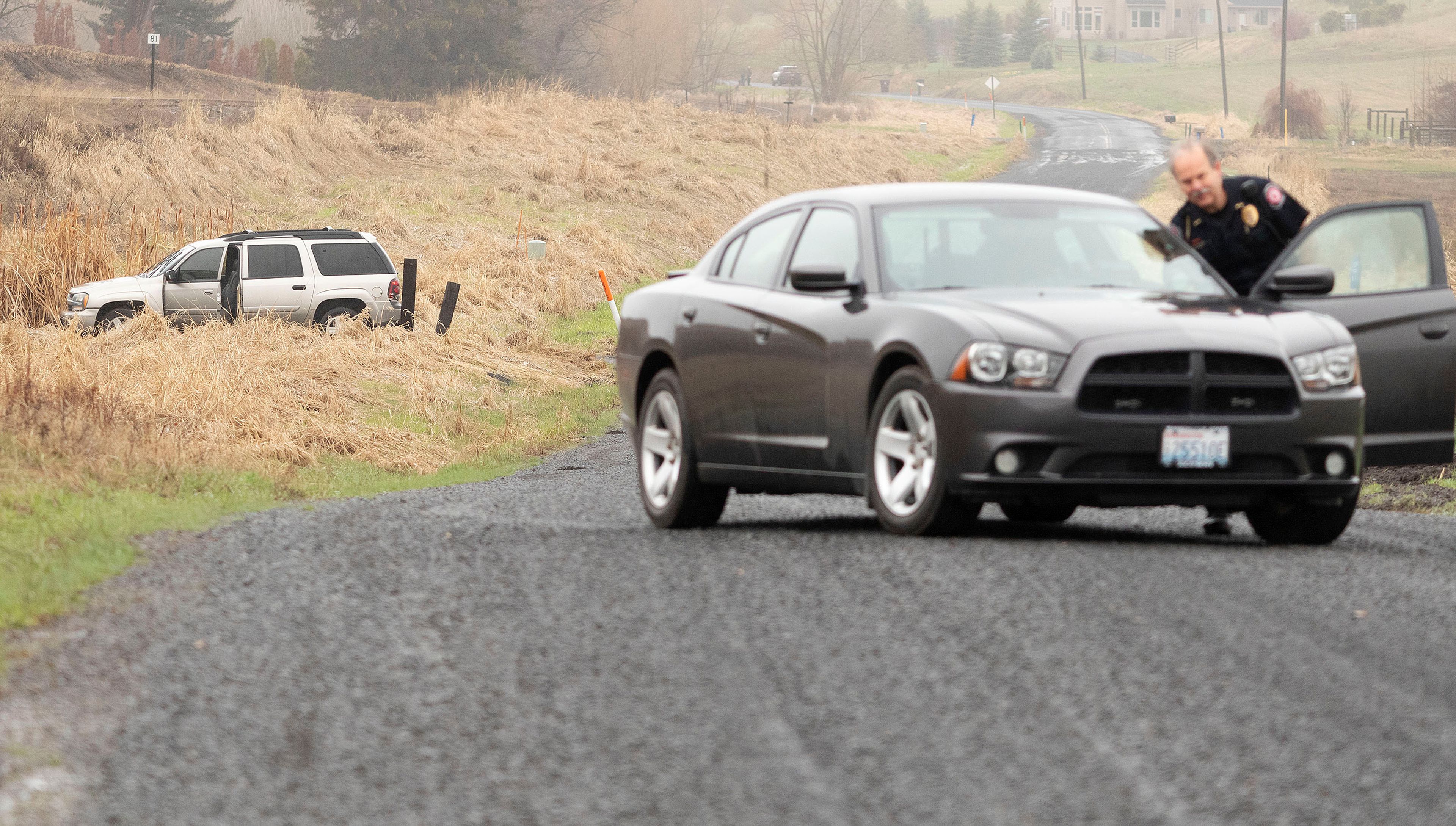 A Washington State University police officer blocks Sunshine Road where a stolen Chevrolet Blazer was found abandoned on Monday east of Pullman. The vehicle was stolen from an employee of Bud Hut by a man who robbed the store at gunpoint.