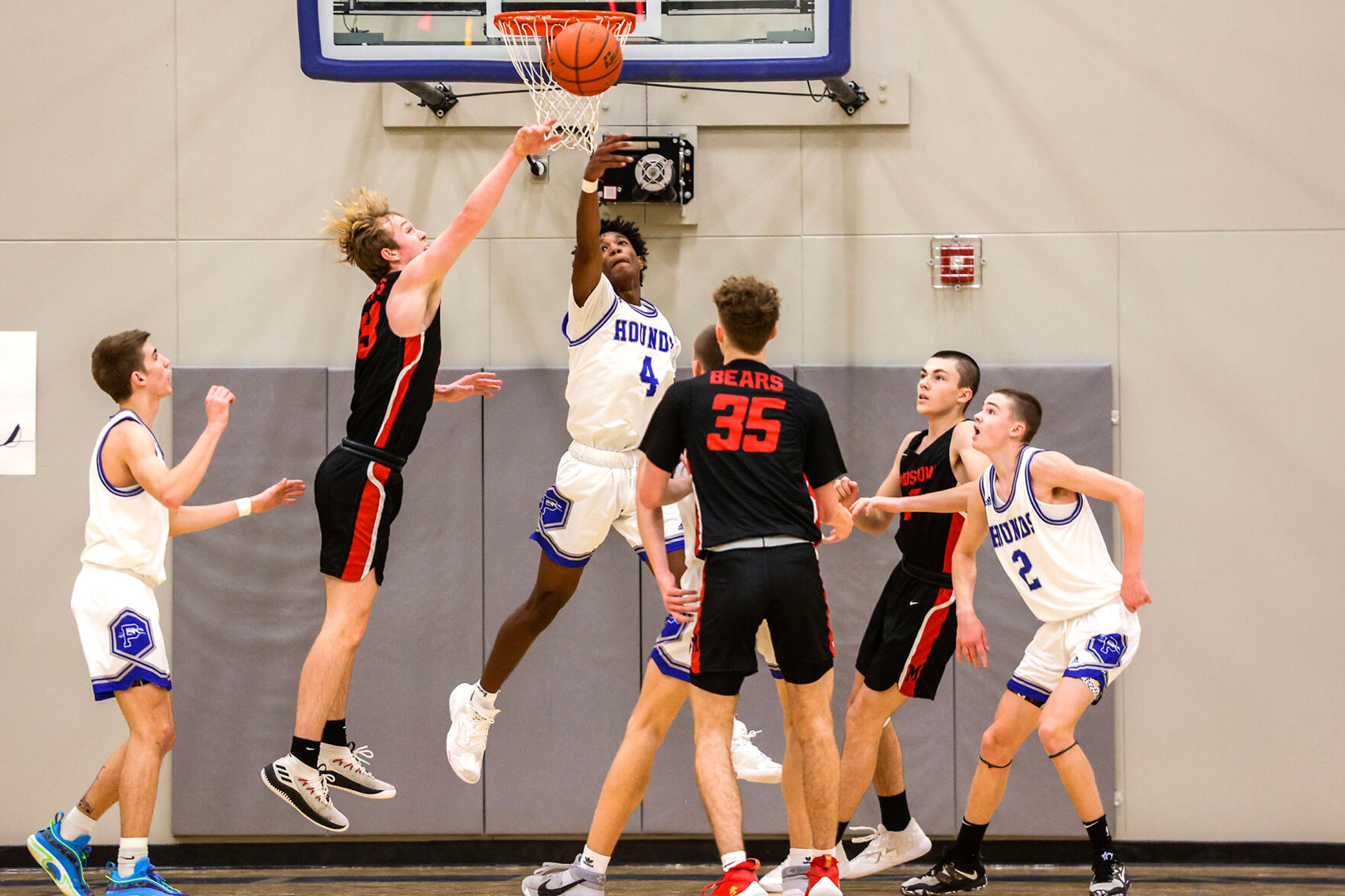 Pullman shooting guard Champ Powaukee, center, tips the ball away from Moscow post Zac Skinner during Saturday's nonleague boys basketball game.