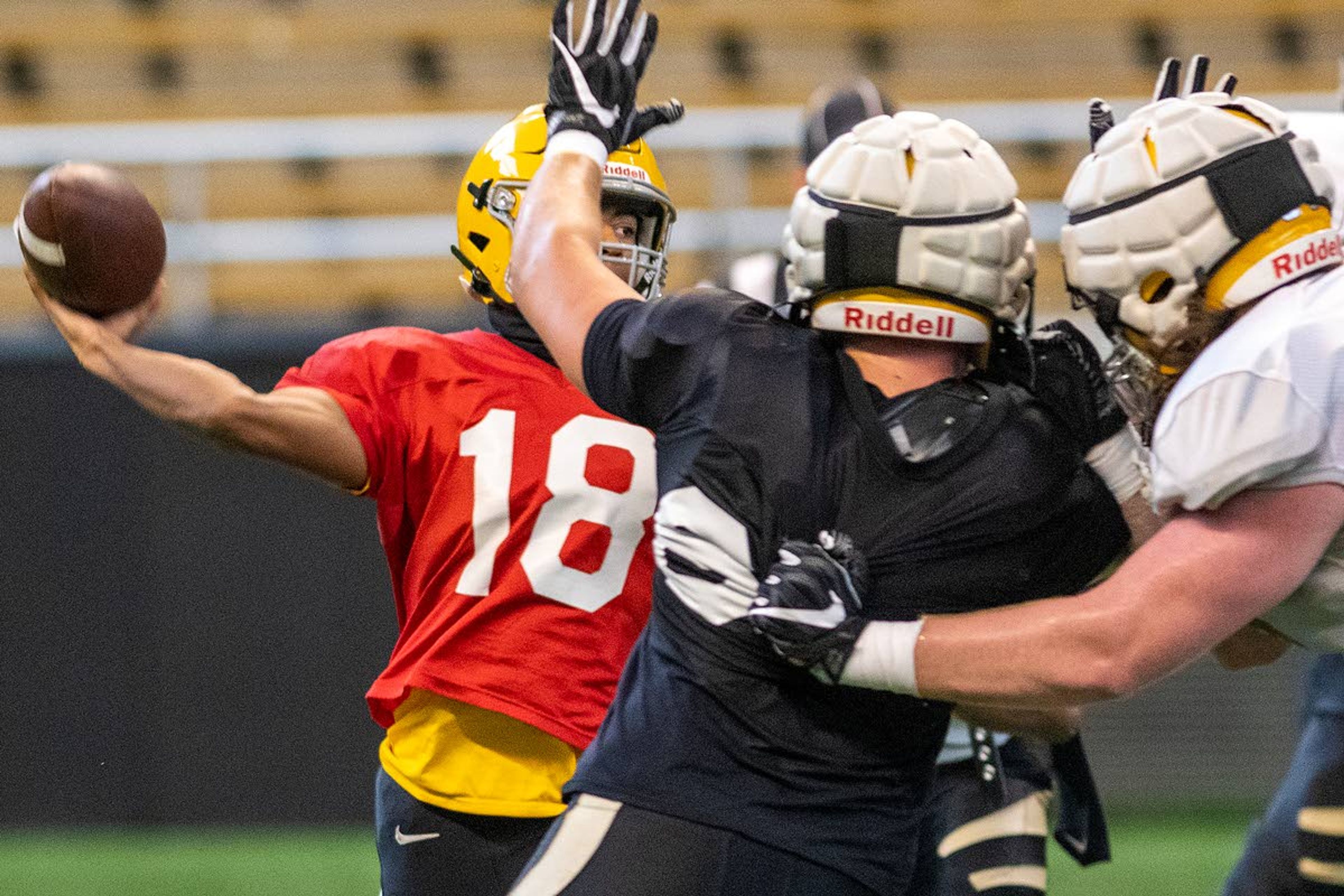 Idaho quarterback Gevani McCoy (18) gets a pass attempt off in the face of a rushing defender during a scrimmage Aug. 21 in the Kibbie Dome.