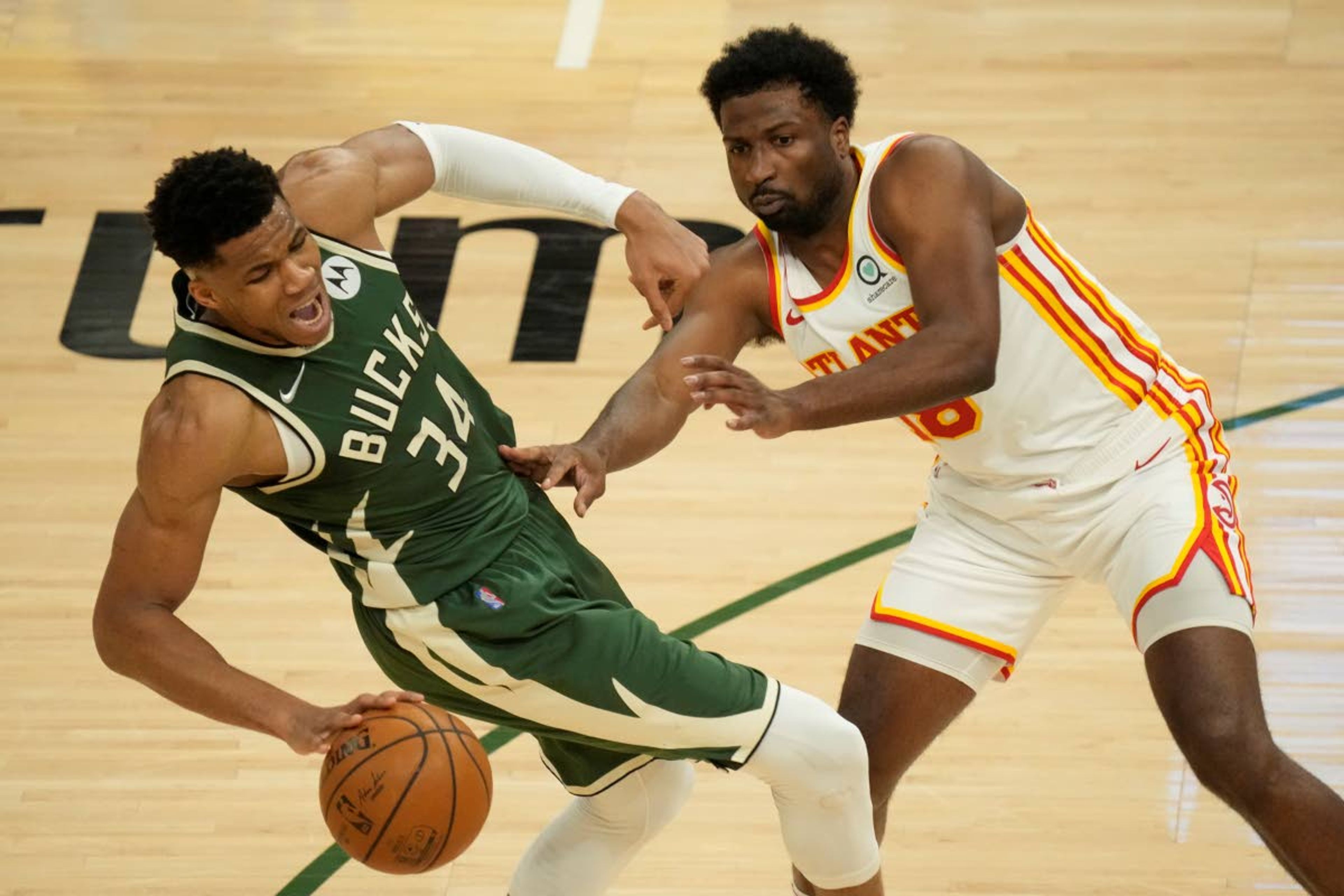 Milwaukee Bucks' Giannis Antetokounmpo is fouled by Atlanta Hawks' Solomon Hill during the first half of Game 1 of the NBA Eastern Conference basketball finals game Wednesday, June 23, 2021, in Milwaukee. (AP Photo/Morry Gash)