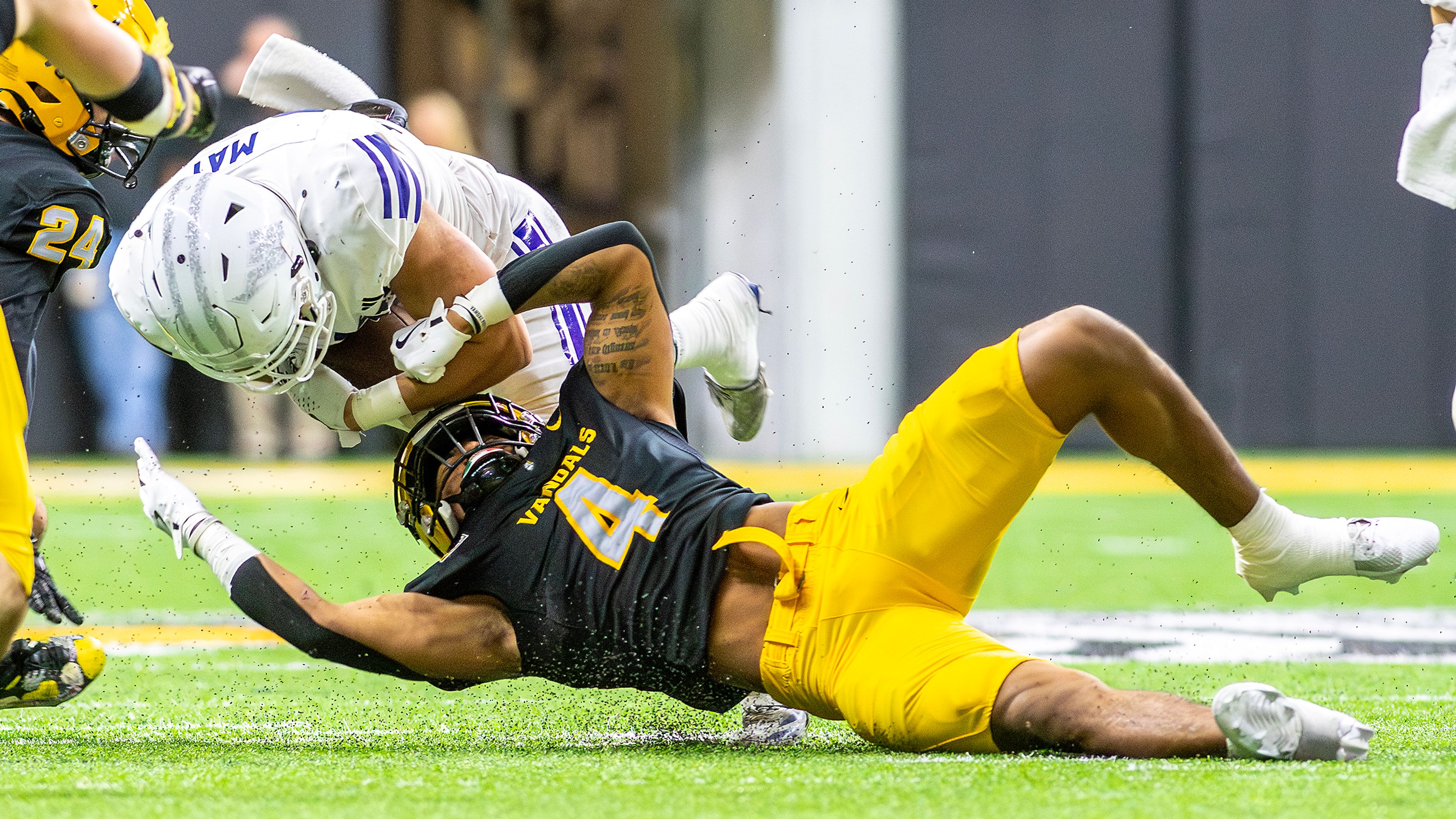 Idaho linebacker Isiah King tackles Weber State running back Colter May during a quarter of a Big Sky conference game Saturday at the P1FCU Kibbie Dome in Moscow.