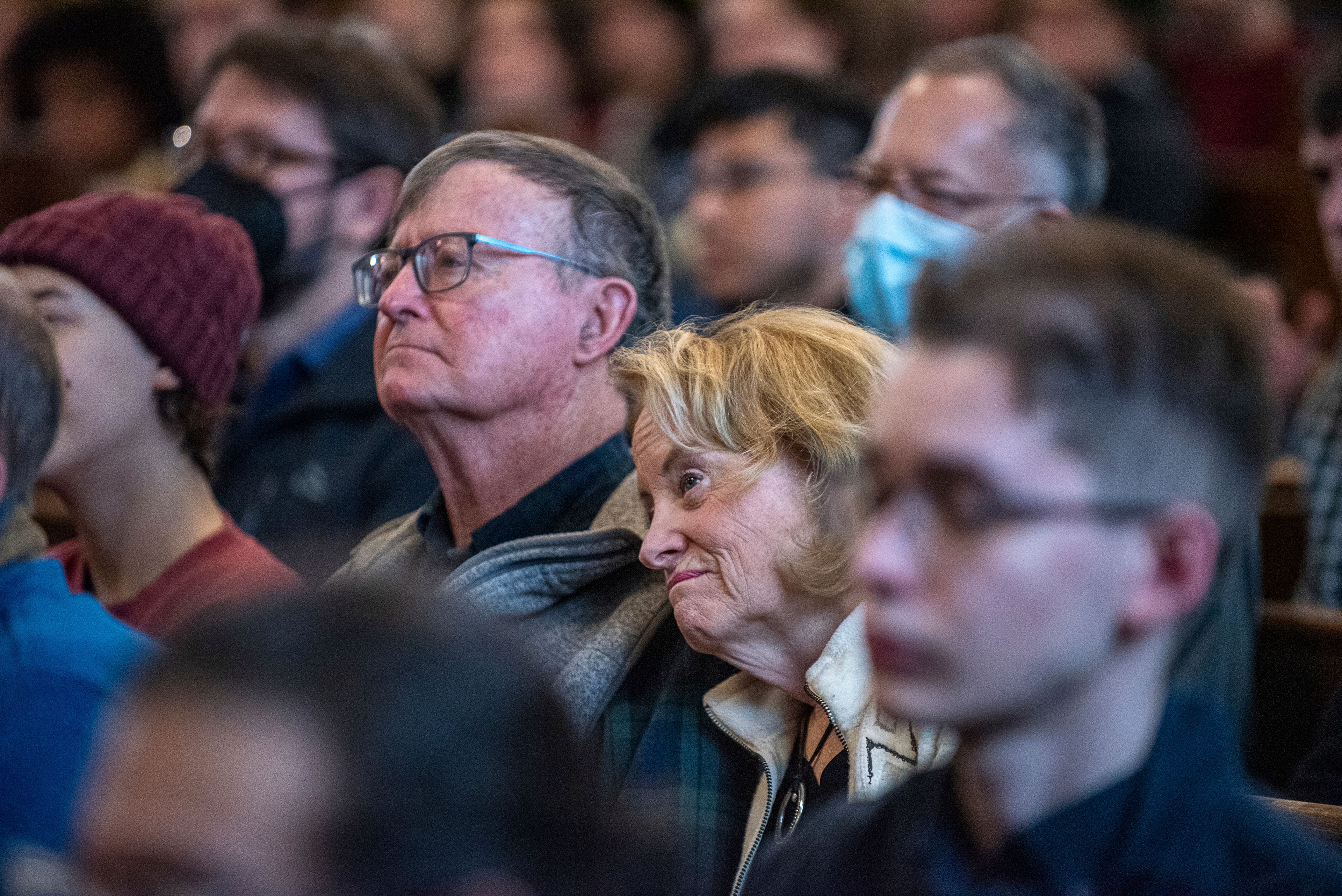 Audience members listen to actor and playwright Keith Hamilton Cobb Monday morning, Jan. 16, 2023, during his keynote speech at Peter J. Gomes Chapel on the campus of Bates College in Lewiston, Maine, during one of several Rev. Dr. Martin Luther King Jr. events during the holiday weekend. Among the capacity crowd in attendance was Robin Hodgskin, center, a Bates alumnus and Arthur Bell, both of Yarmouth, who make it a tradition to come hear the keynote speaker every year during the MLK day events at the Lewiston college. (Russ Dillingham/Sun Journal via AP)