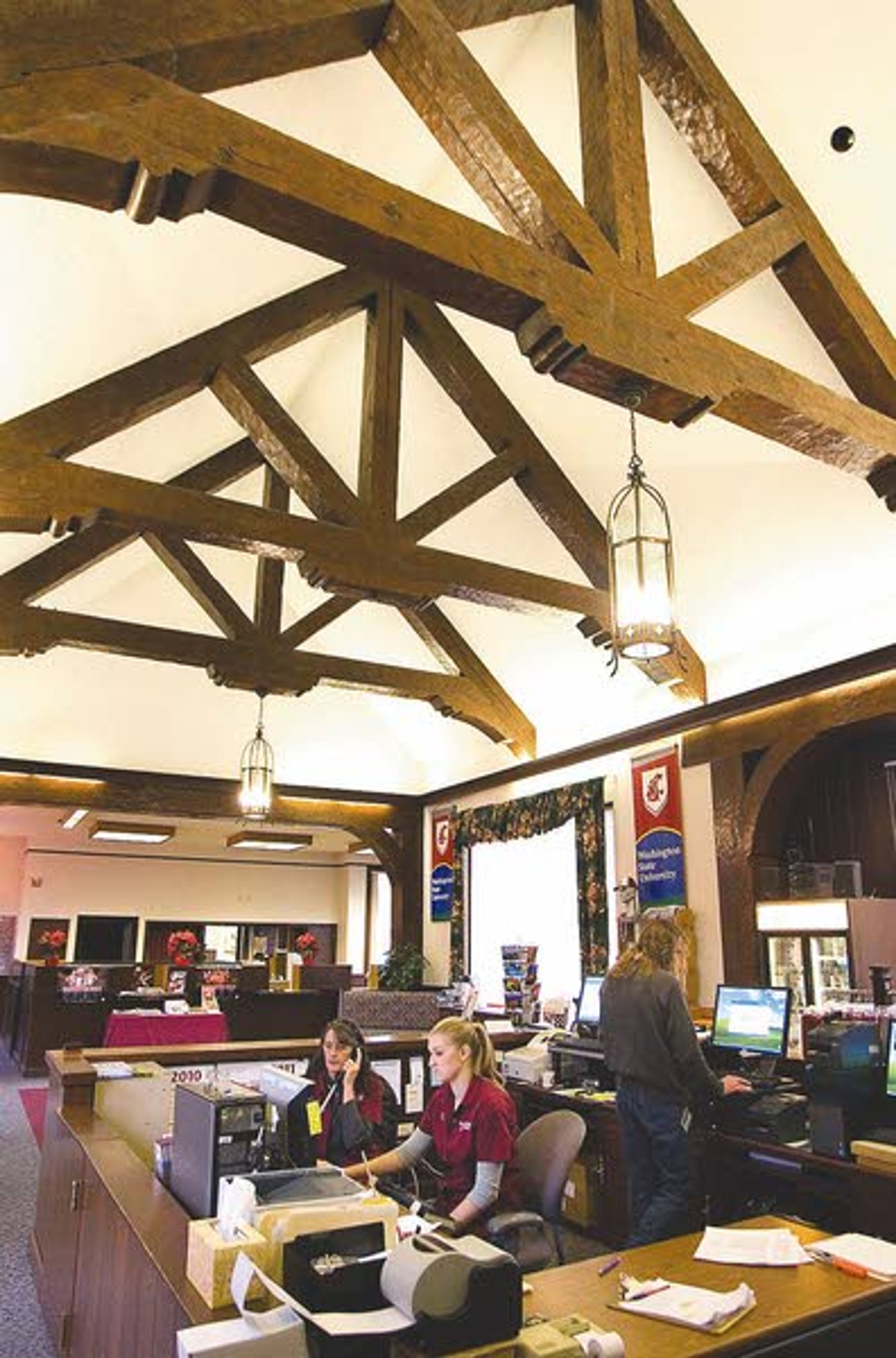 Cindy Held, left, and Annie Breyman work in the WSU Visitor
Center in downtown Pullman on Wednesday. The university is
considering selling the building.