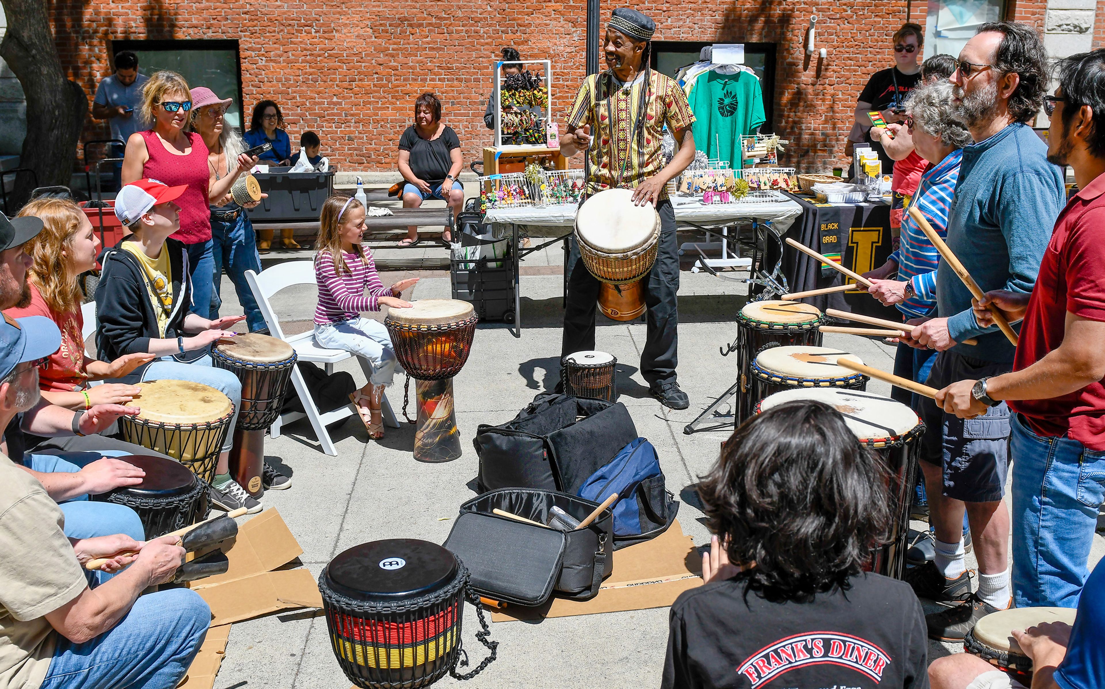 Darryl Singleton, center, a jazz faculty member at the Washington State University School of Music, leads a drum circle made up of community members attending the Juneteenth celebration on Wednesday in Moscow’s Friendship Square.