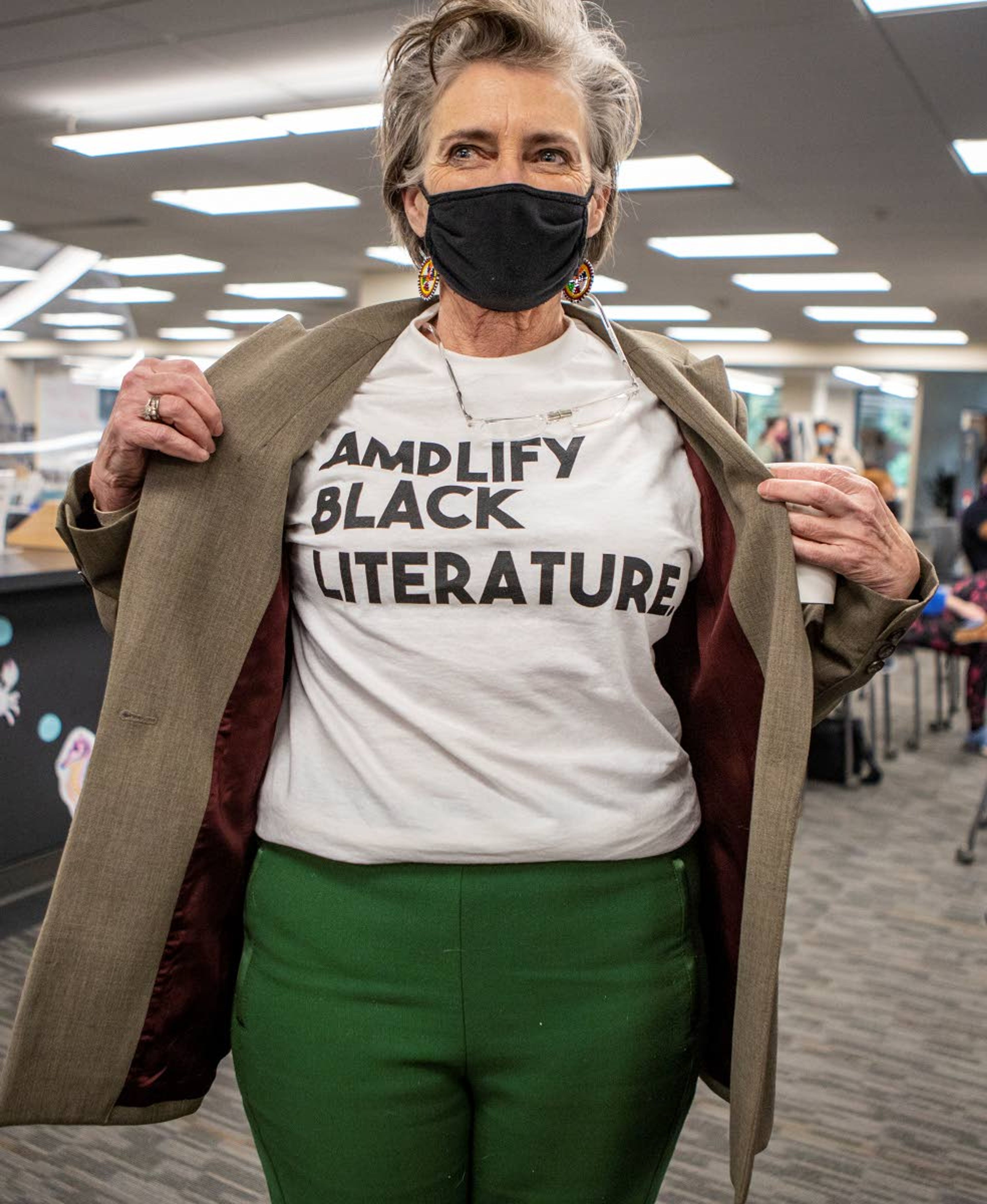 University of Idaho professor Jan Johnson shows off her “Amplify Black Literature” shirt Tuesday during the opening reception of the "Black History at U of I" exhibit on the first floor of the UI library in Moscow. Johnson is an associate professor in the English department and director of the Africana Studies Program at UI.