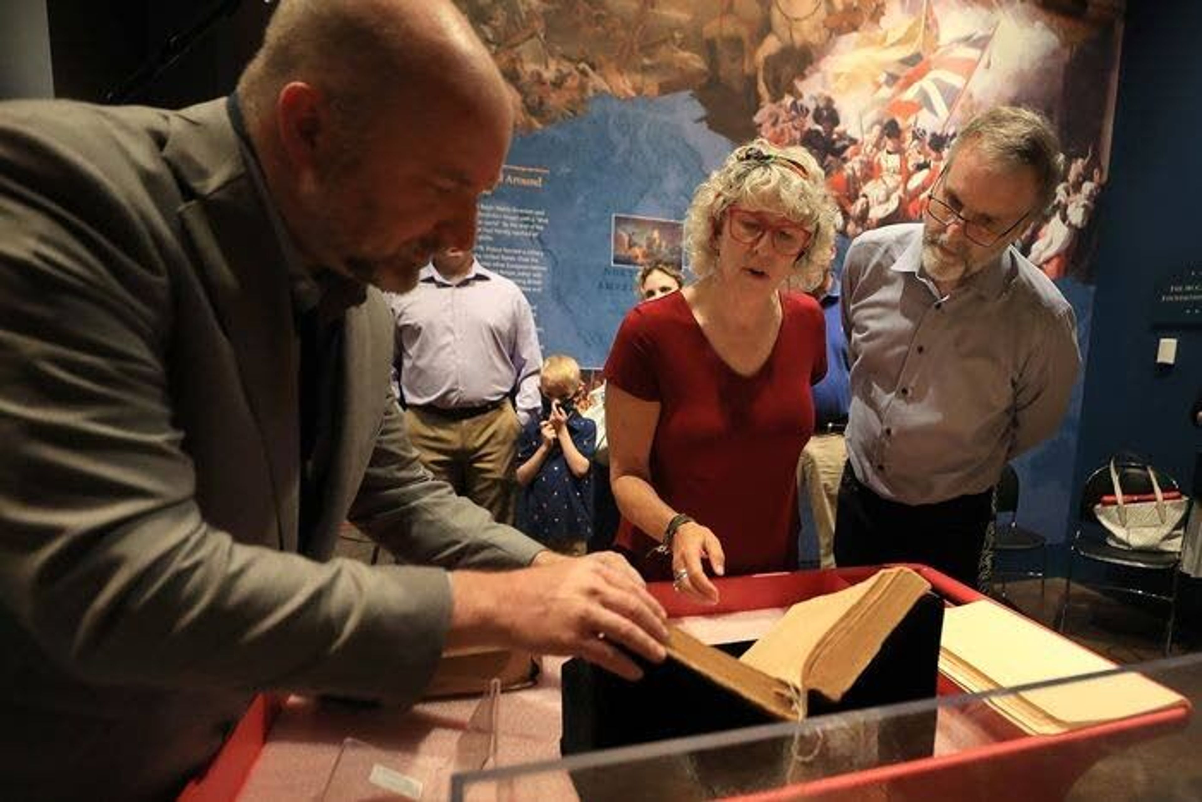 Photos by David Maialetti/TNSChief historian and curator Philip Mead, left, of the Museum of the American Revolution, looks over the Claypoole family Bible with Aileen and David Edge inside the museum. The Edges’ donated the Bible to the museum.