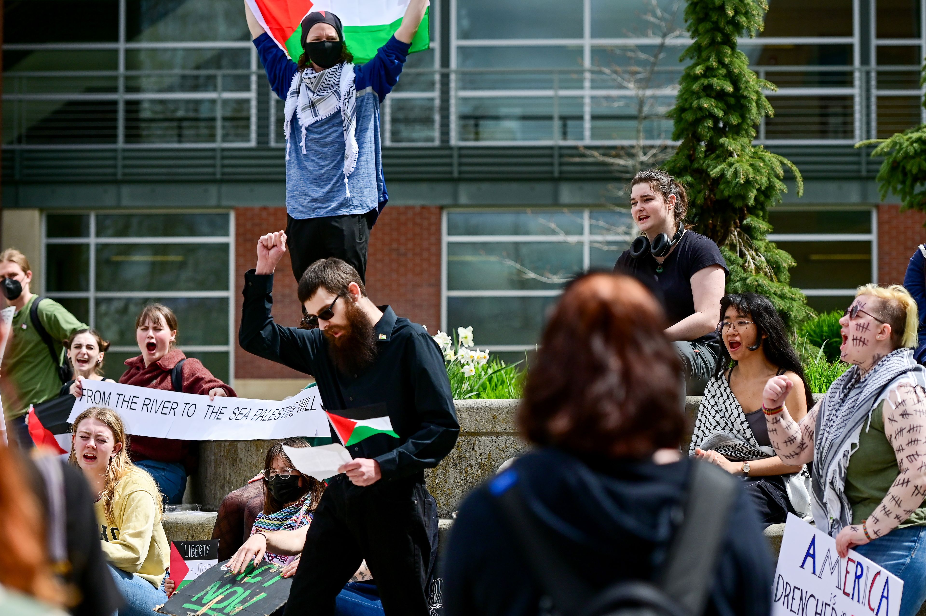 The crowd gathered at a pro-Palestine demonstration on Thursday respond to the call, “From the river to the sea,” from Sam Gironde, center, a University of Idaho alumnus and long-term Moscow resident, with “Palestine will be free,” at the end of an address from Gironde outside of the UI Library in Moscow.