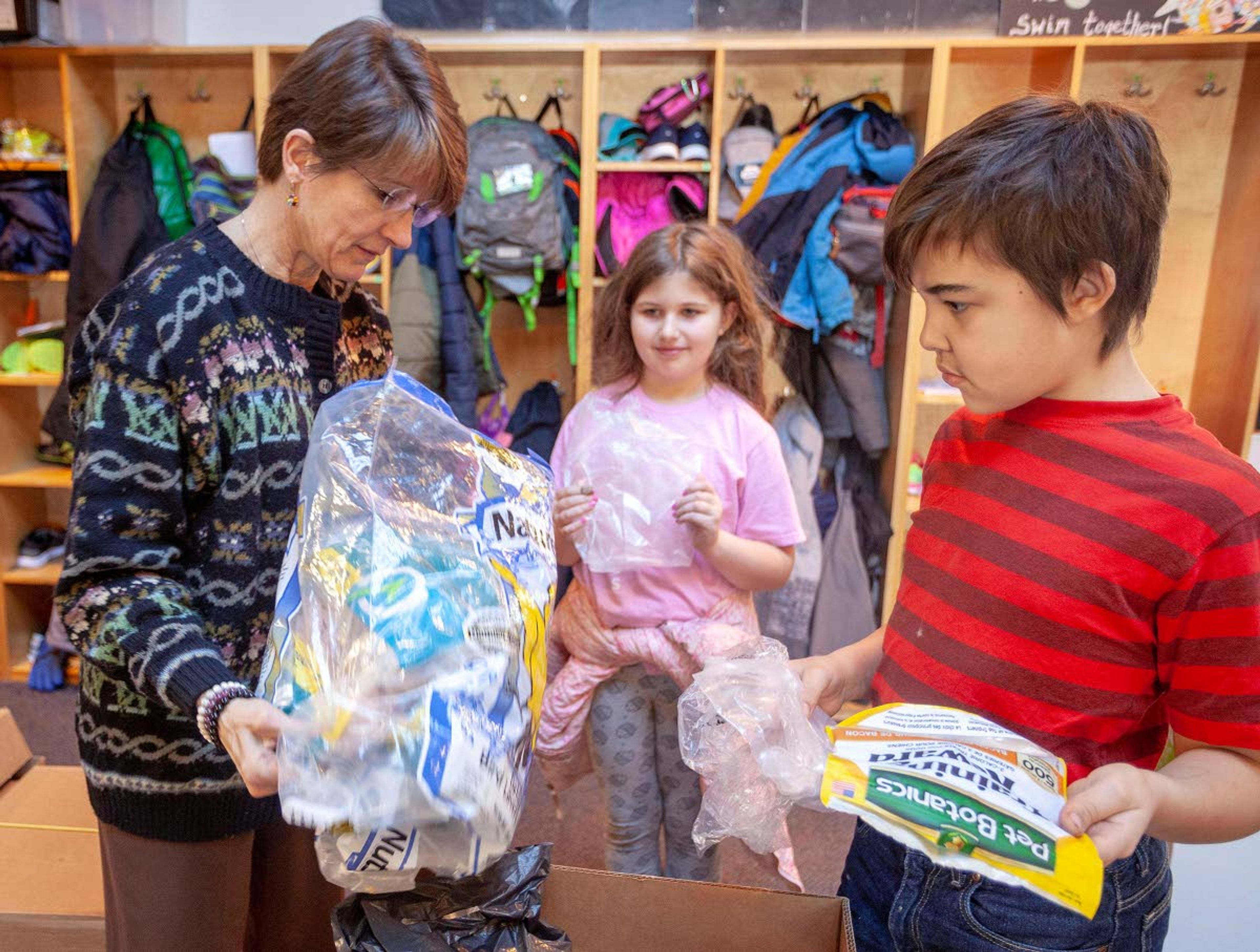 In this photo from January 2019, Moscow Charter School teacher Kathryn Bonzon, left, and students Meredith Johnson and Ian Mitton talk about some of the plastic bags that have been donated to their recycling program.