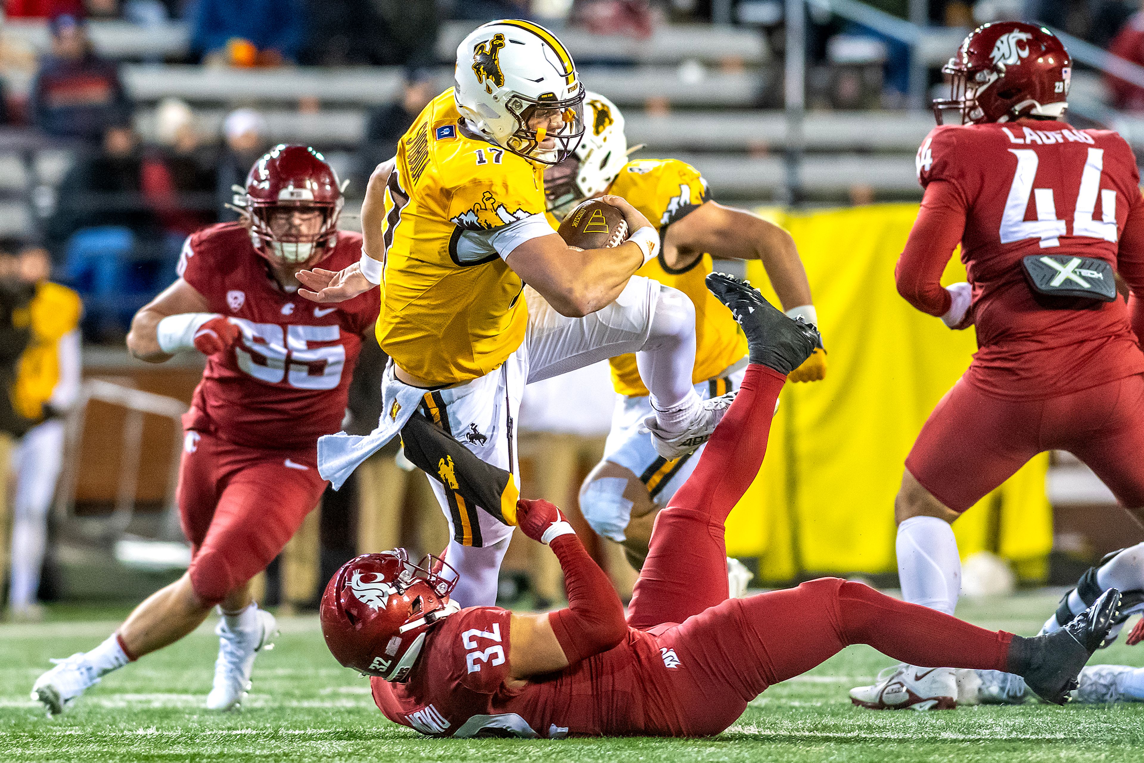 Wyoming quarterback Evan Svoboda hangs onto the ball as Washington State defensive back Tanner Moku attempts to bring him down during a quarter of a college football game on Saturday, at Gesa Field in Pullman. Wyoming defeated Washington State 15-14.