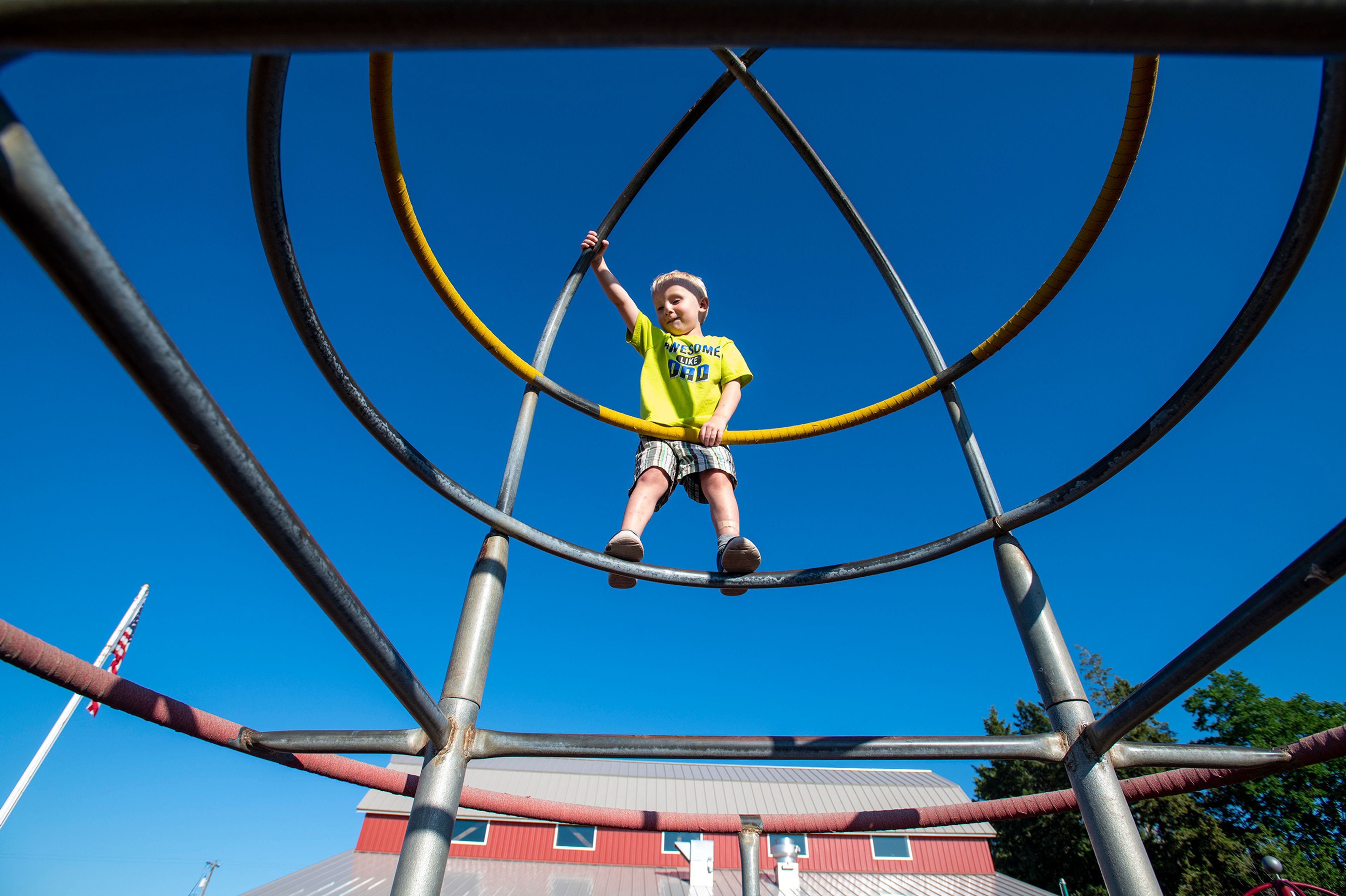 Riley Humphrey, 3, climbs a piece of equipment Thursday evening at the Viola Community Center playground.