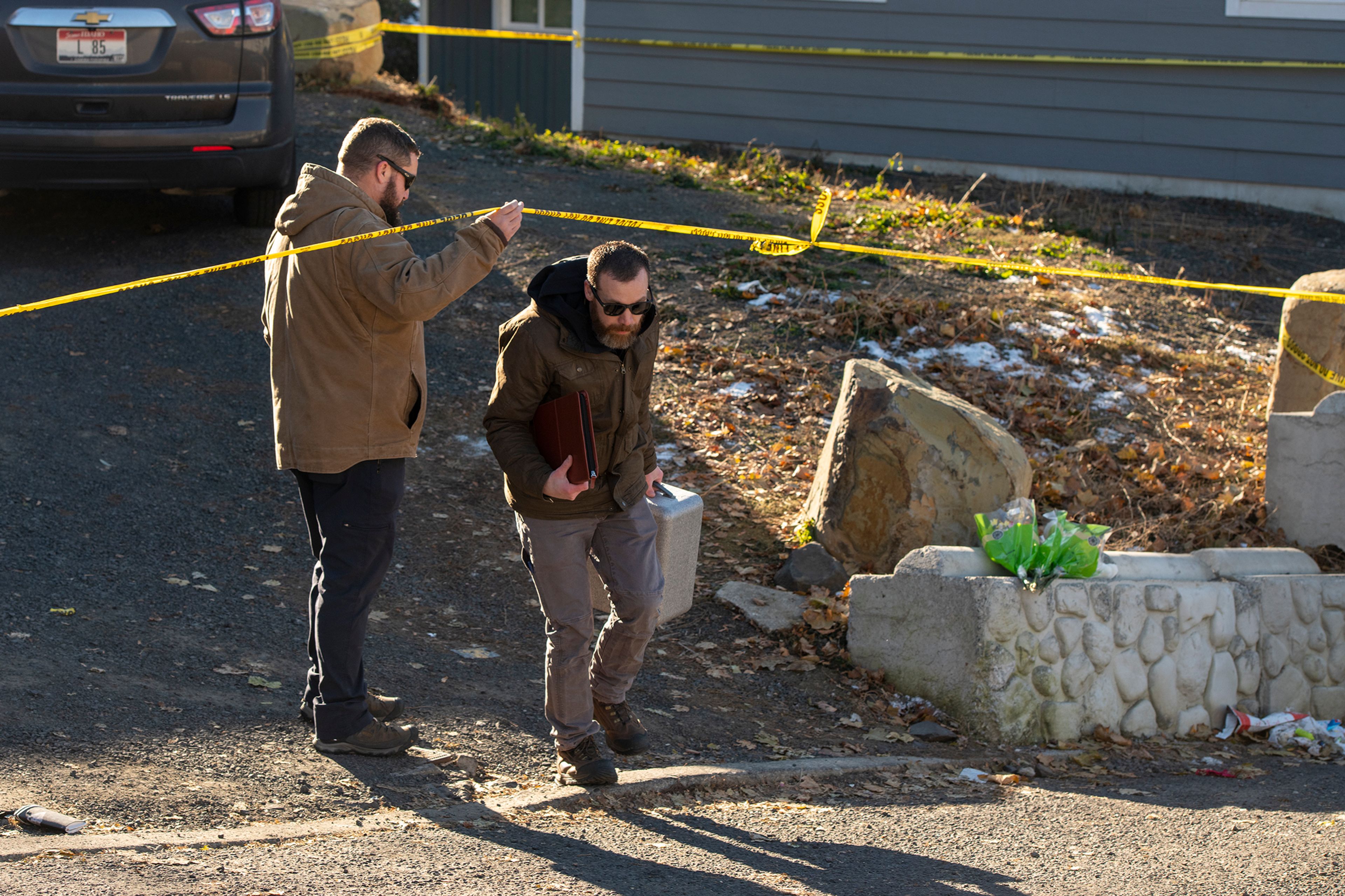 Officers leave the scene Friday at a home where four University of Idaho students were recently murdered over the weekend in Moscow.