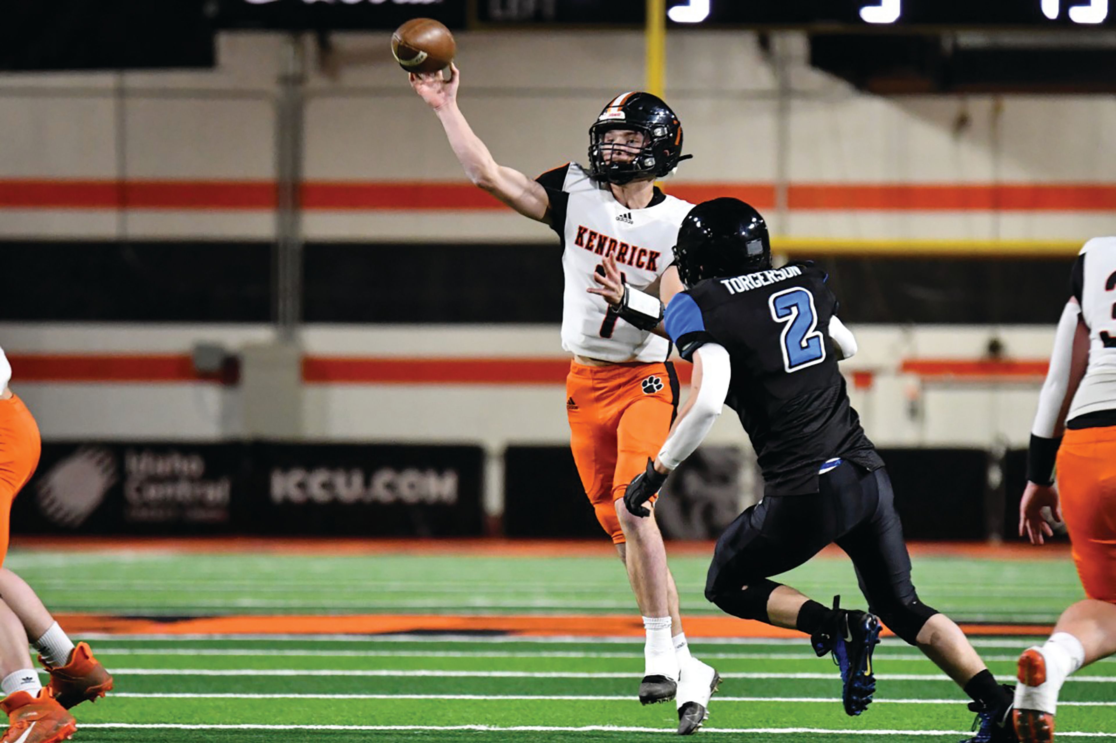 Scott Kirtley/For The Tribune Kendrick junior quarterback Ty Koepp throws a pass as Dietrich linebacker Brody Torgerson tries to close in during Friday's Idaho Class 1A Division II football state championship game at Holt Arena in Pocatello.