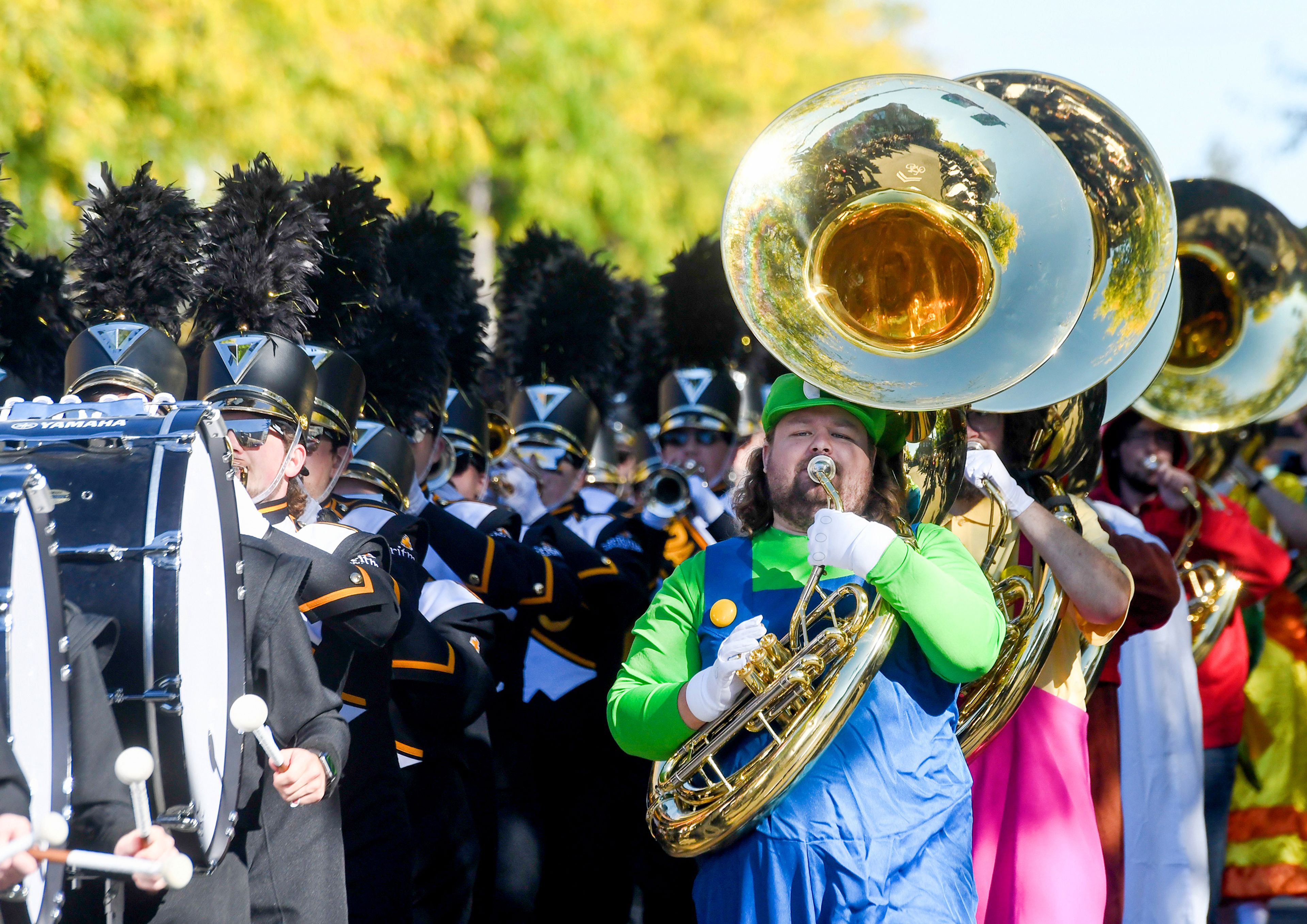 The tuba section of the Vandal Marching Band dress as Super Mario Bros. characters for their march down Main Street in the Homecoming Parade Saturday in Moscow.