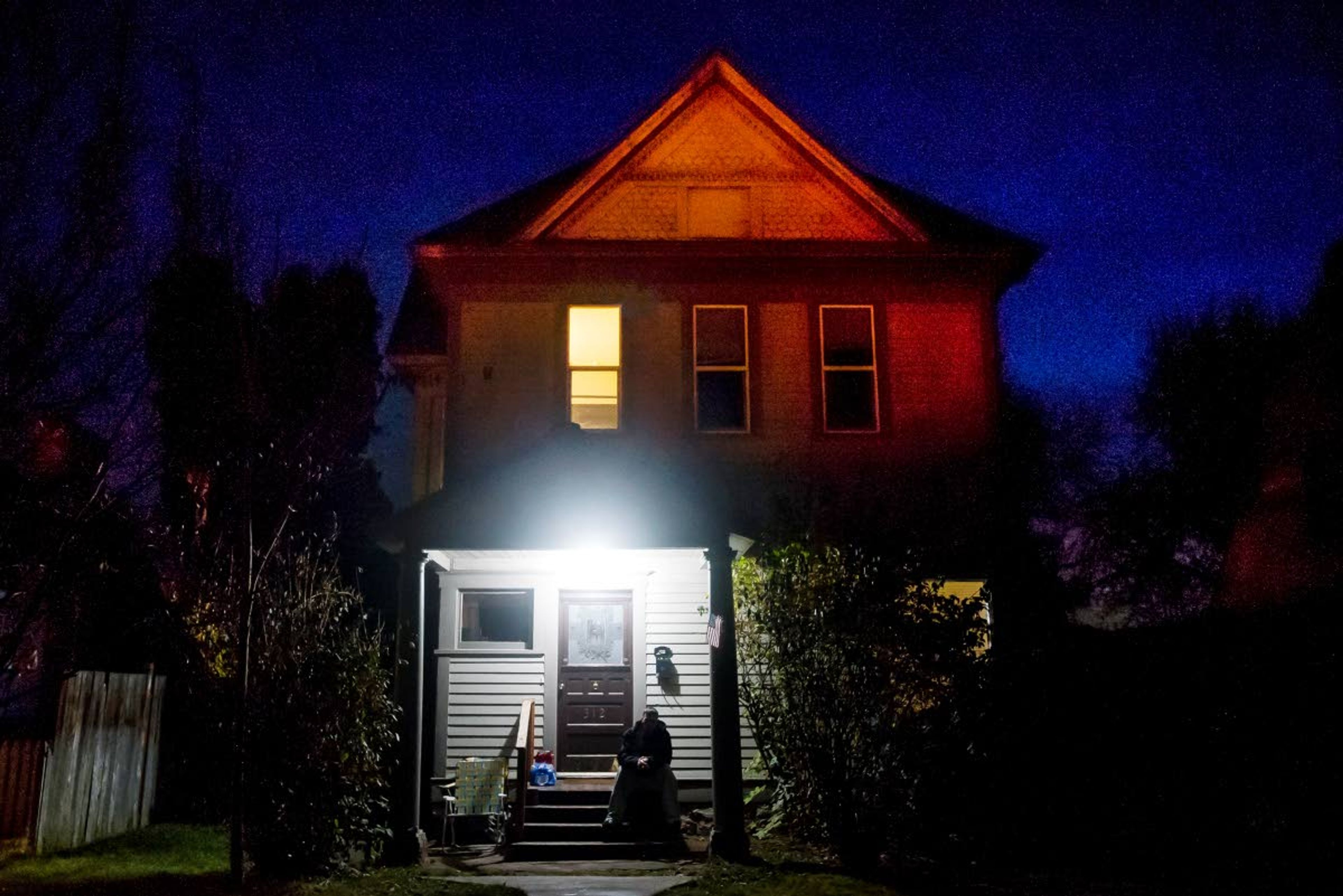 Shaun McArthur sits on the front steps of one of two men's Oxford Houses in Lewiston on Friday night. "I thank god I found Oxford House," said McArthur.