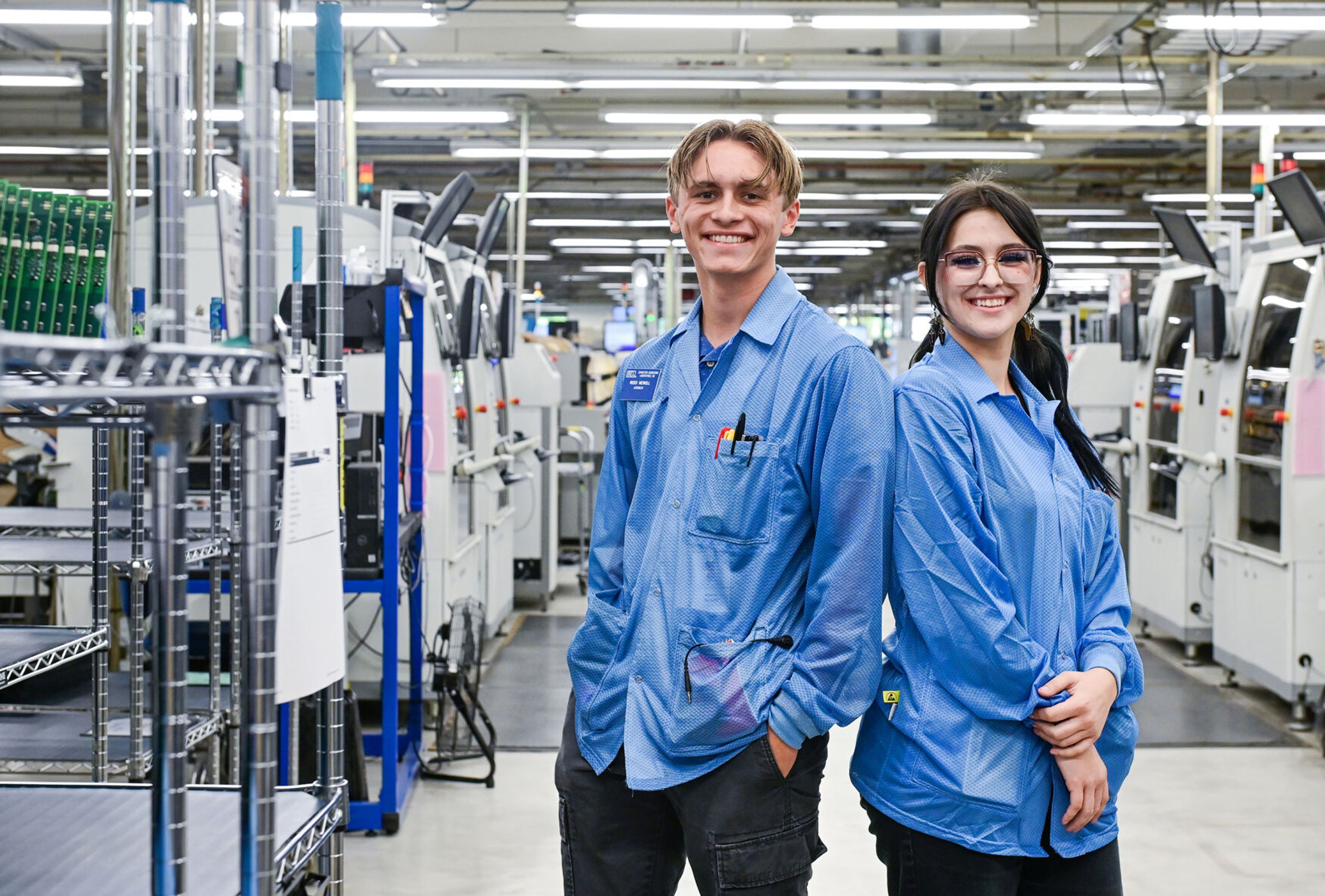 Pullman High School seniors and members of the Summer Assembler Program Reed Newell, left, and Anina Swanson stand at Schweitzer Engineering Laboratories, where the two worked over the summer, on Thursday in Pullman.