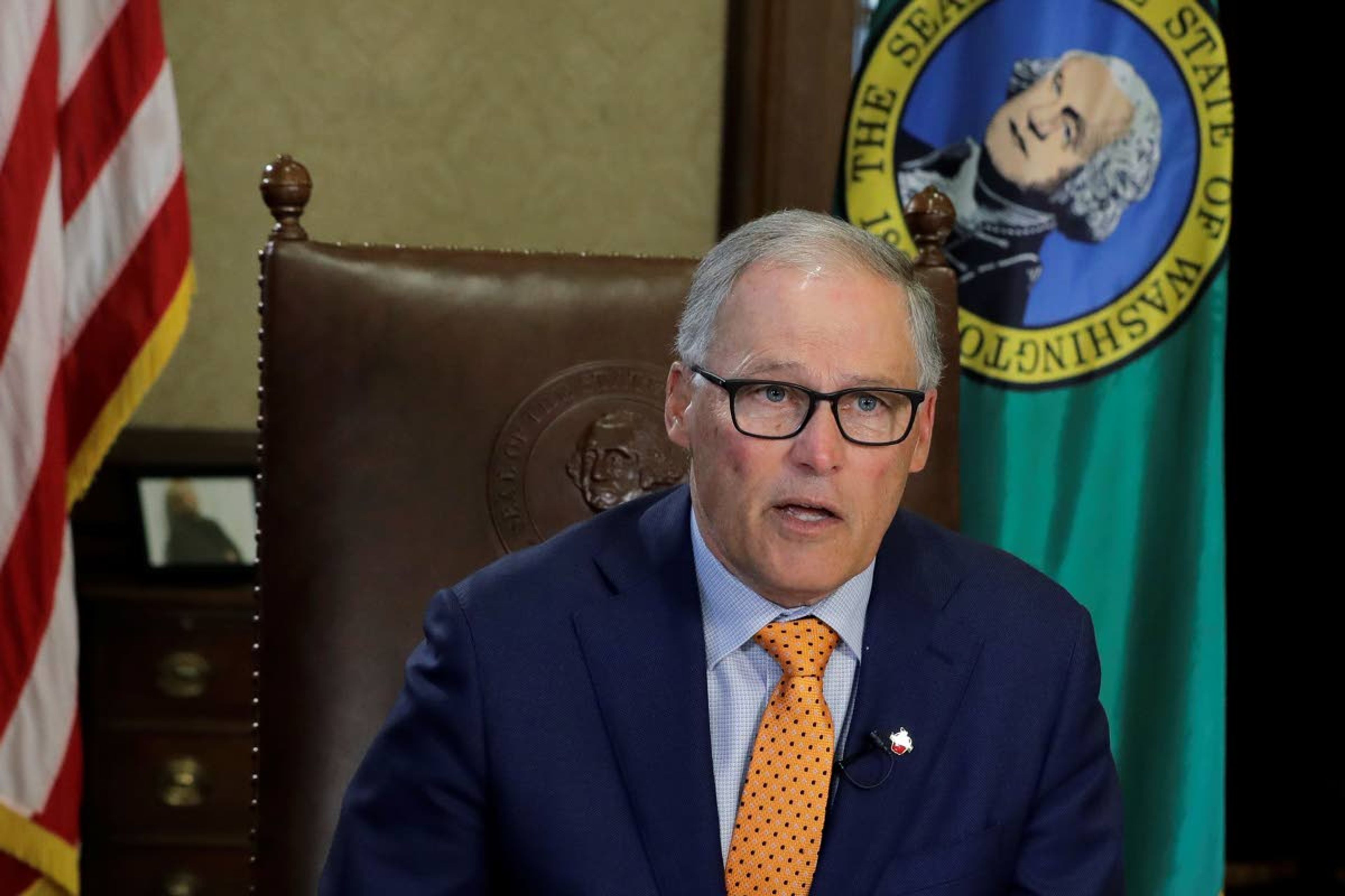 Washington Gov. Jay Inslee sits at his desk and rehearses a speech Tuesday, April 21, 2020, at the Capitol in Olympia, Wash., minutes before going live to address the public on the state's next steps in addressing the coronavirus outbreak. Inslee said the state will not be able to lift many of the stay-at-home restrictions implemented to fight the coronavirus by May 4, the date through which the existing directive is currently in place. (AP Photo/Ted S. Warren)