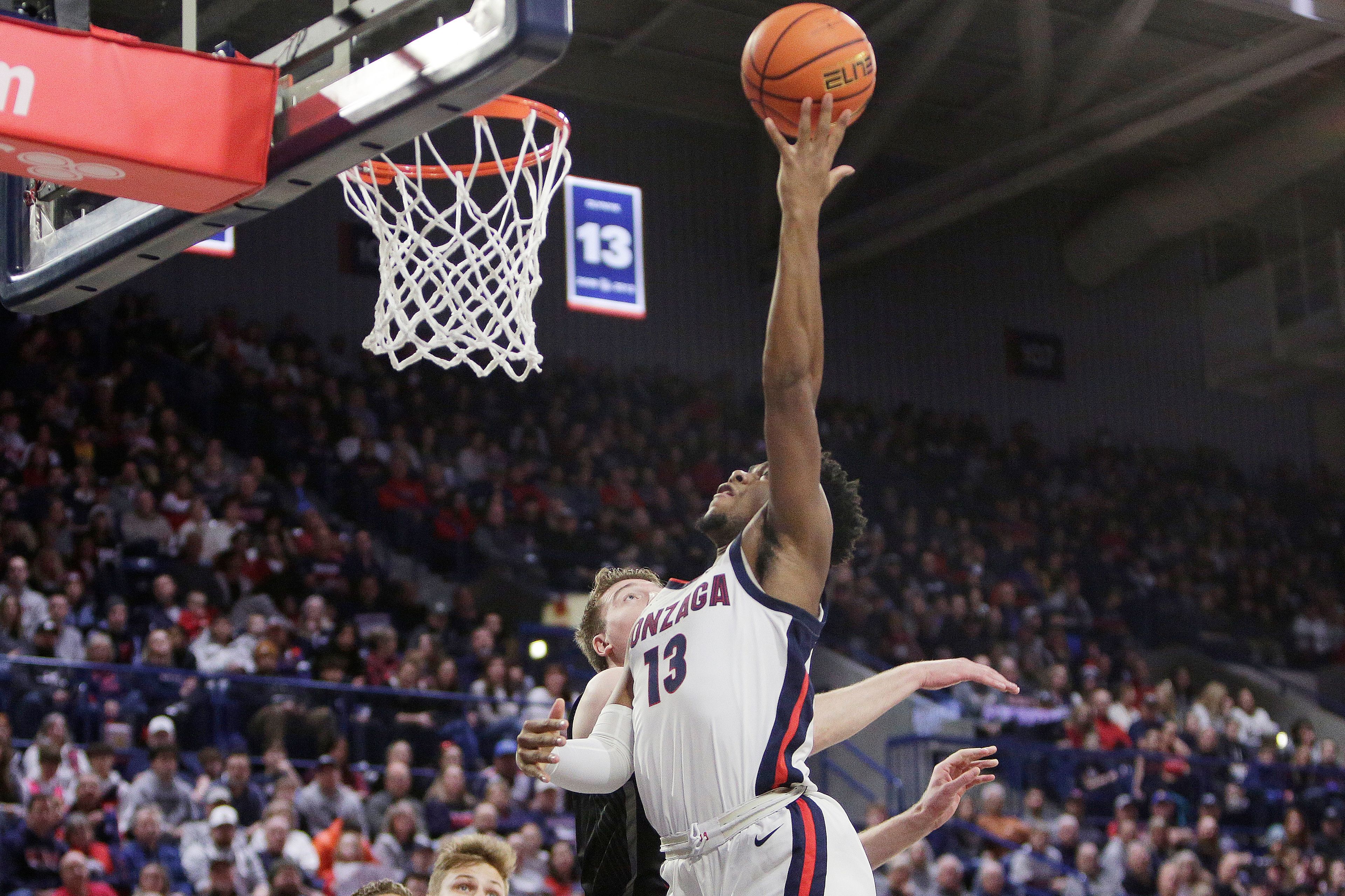 Gonzaga guard Malachi Smith, right, shoots while defended by Eastern Oregon forward Slade Dill during the first half of a college basketball game, Wednesday, Dec. 28, 2022, in Spokane, Wash. (AP Photo/Young Kwak)