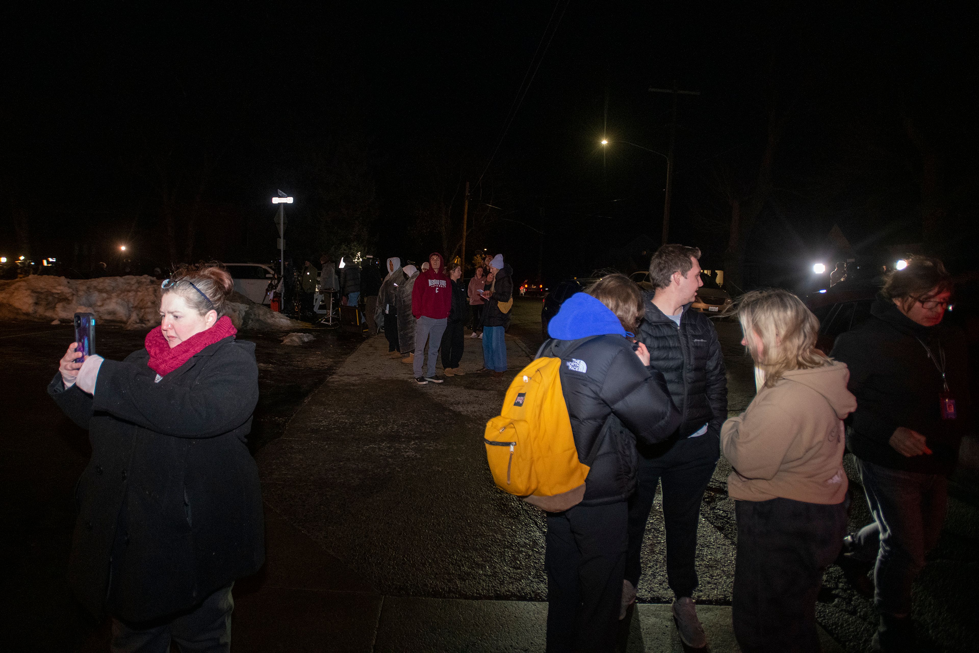 People gather outside of the Latah County Sheriff’s Office as Bryan Kohberger is transported to Moscow on Wednesday evening.