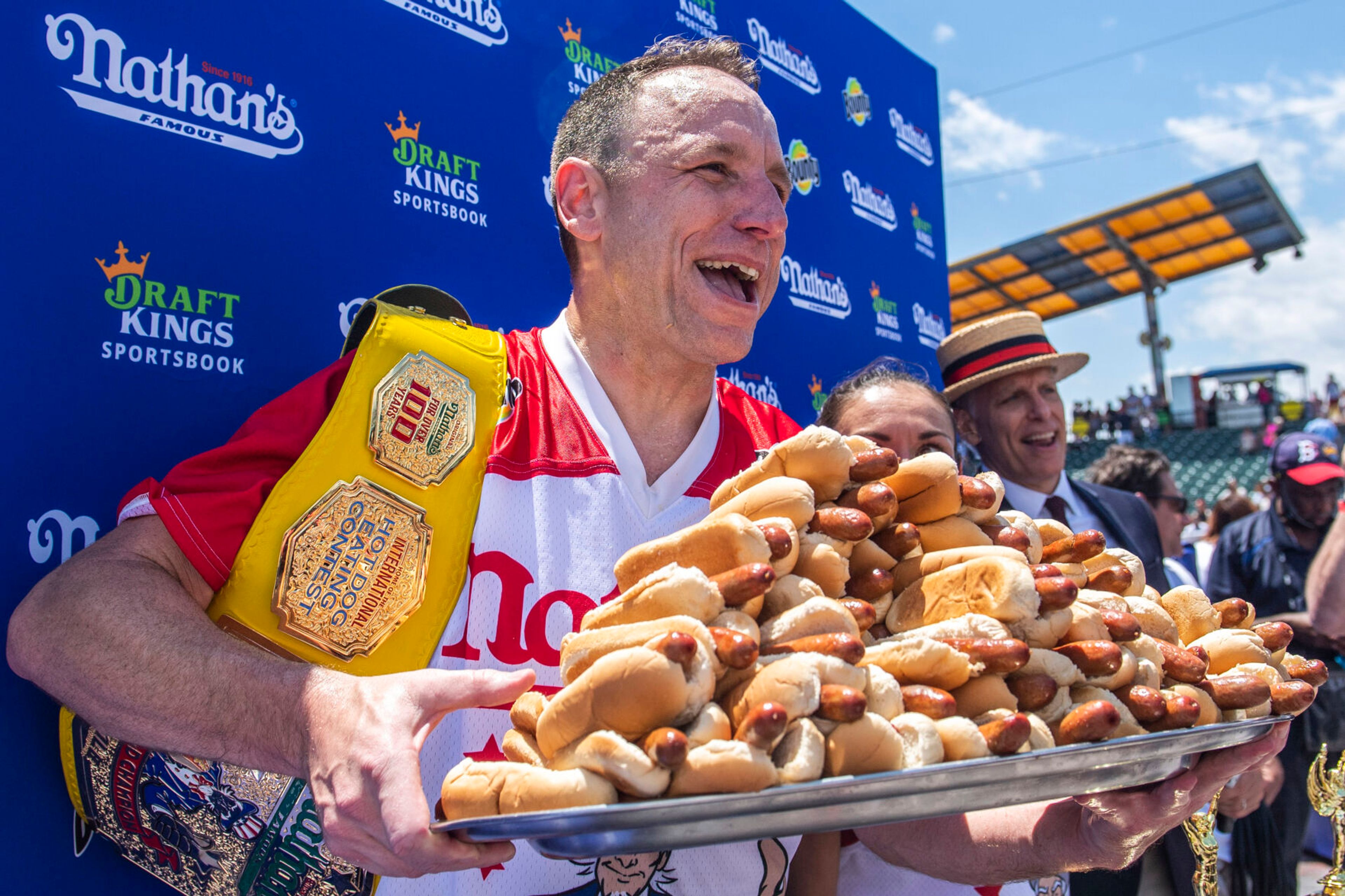 FILE - Joey Chestnut, winner of the 2021 Nathan's Famous Fourth of July International Hot Dog-Eating Contest, poses for photos in Coney Island's Maimonides Park, July 4, 2021, in the Brooklyn borough of New York. Chestnut will take his hot dog-downing talents to an army base in Texas for America's Independence Day this year, after a falling out with organizers of the annual New York City-based event. (AP Photo/Brittainy Newman, File)