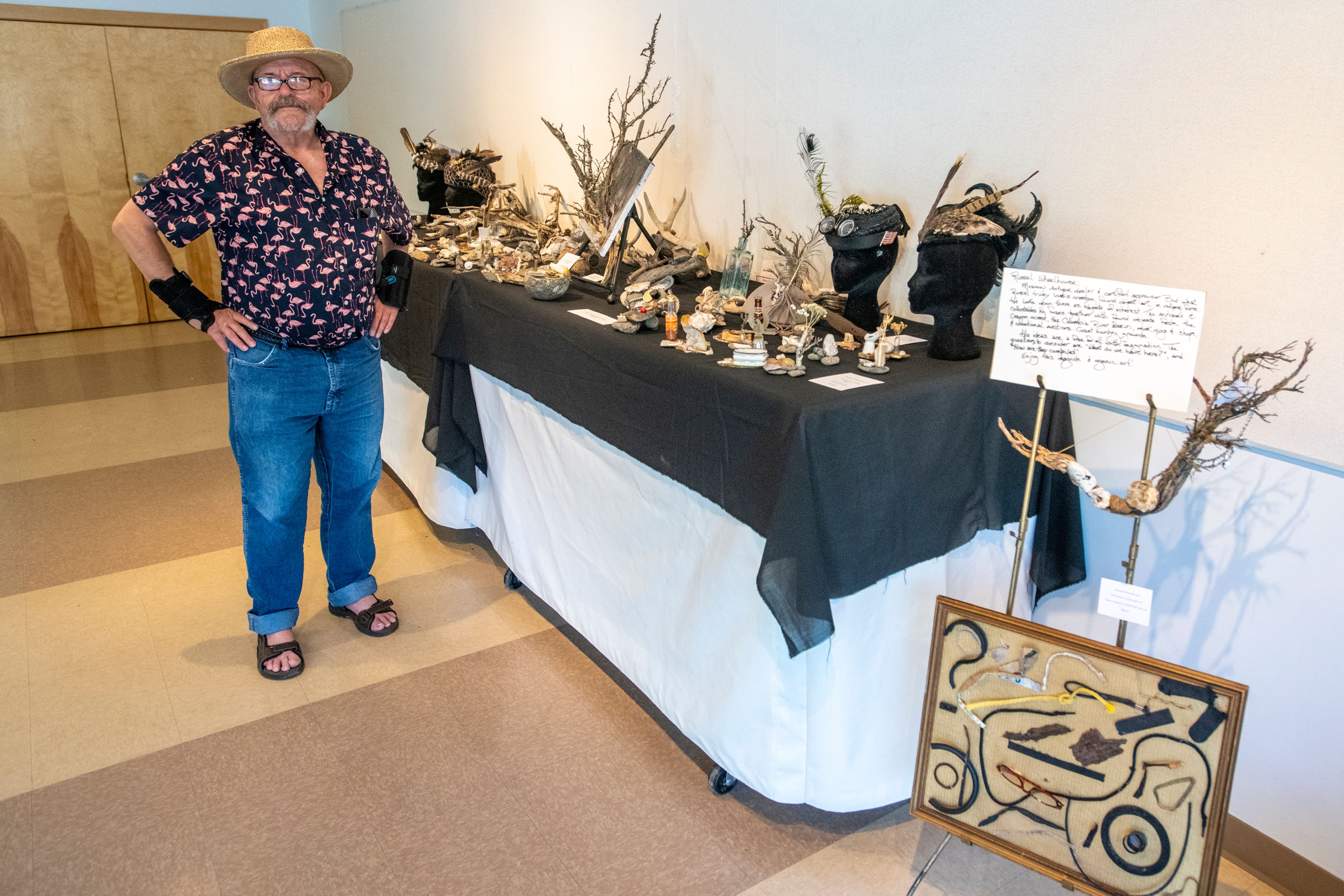 Artist Russell Wheelhouse, of Moscow, stands beside his gallery of recycled artwork at the Palouse Community Center for the 17th Annual Palouse ArtWalk.