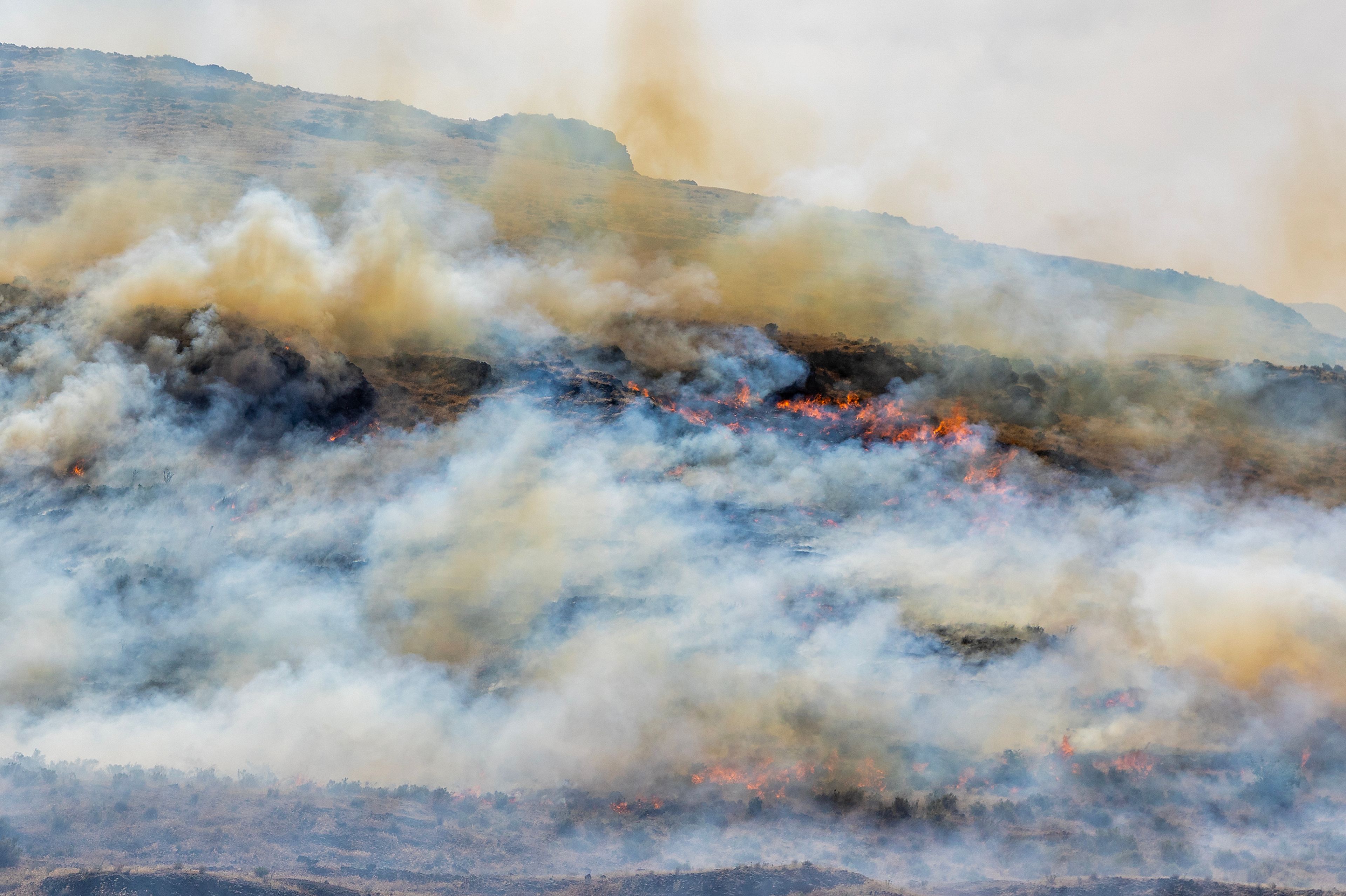 A grass fire burns along the hillside nearby Nisqually John Landing Friday off of Wawawai Road.