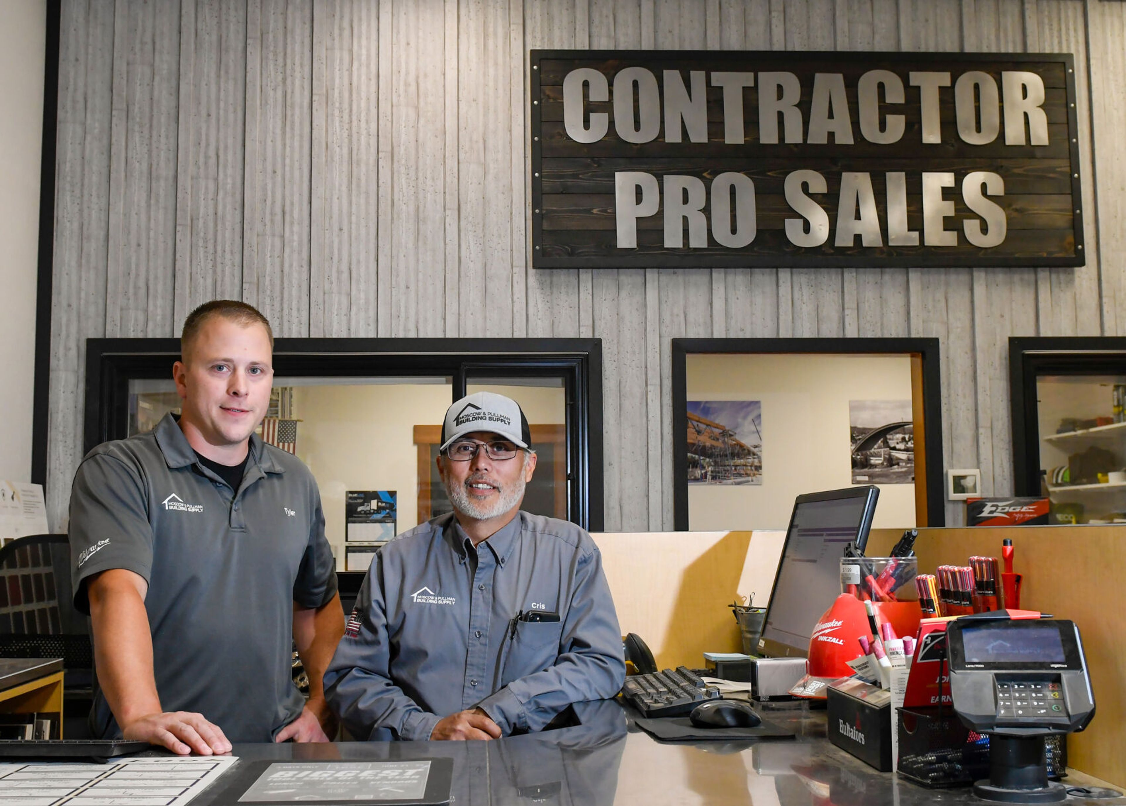 Tyler Garrett, president and CEO of Moscow & Pullman Building Supply, stands at the contractor sales desk with Cris Quezada, right, 27-year employee with outside contractor sales, at Moscow Building Supply on Wednesday.