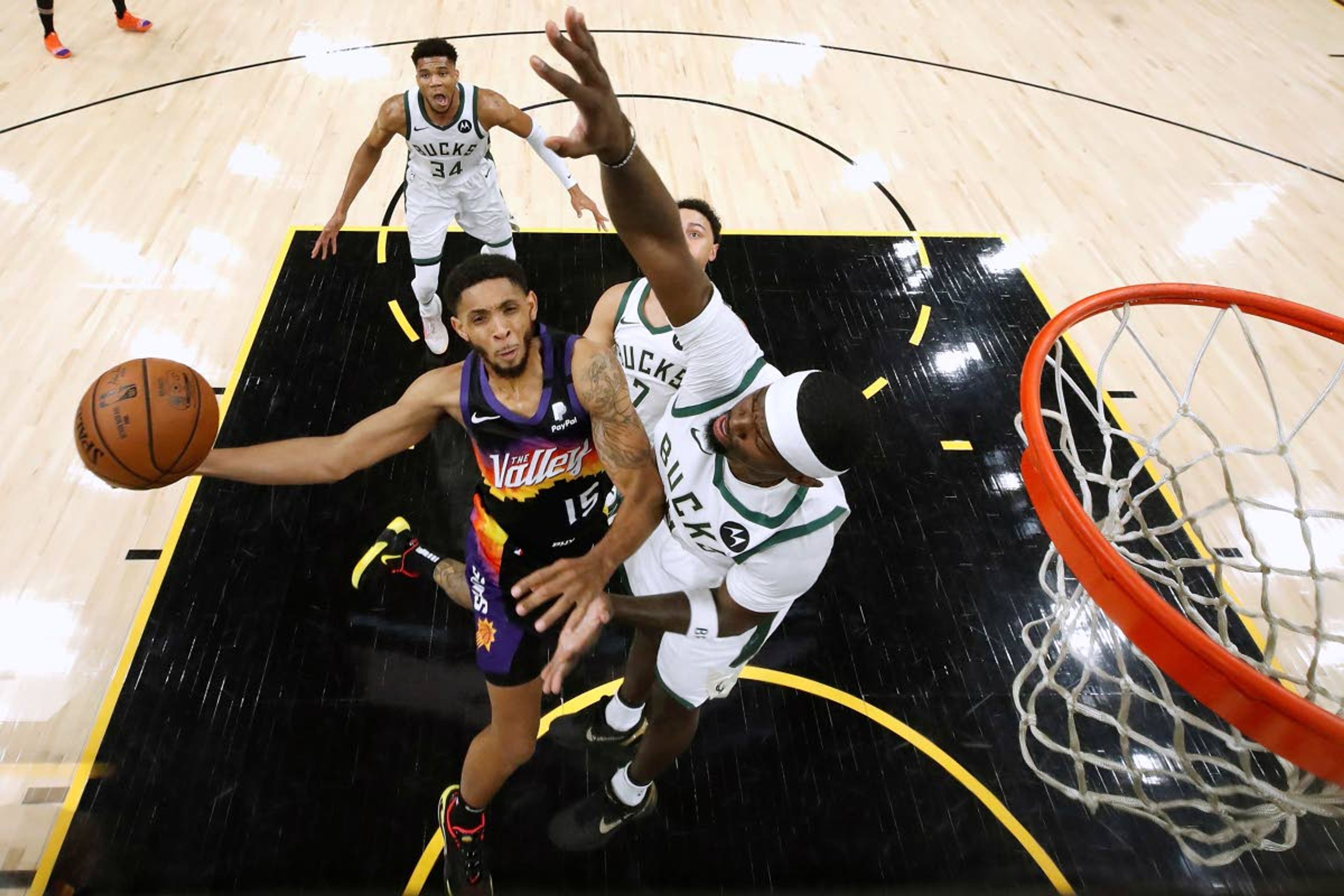 Phoenix Suns' Cameron Payne (15) shoots as Milwaukee Bucks' Bobby Portis (9) defends during the first half of Game 2 of basketball's NBA Finals, Thursday, July 8, 2021, in Phoenix. (Christian Petersen/Pool Photo via AP)