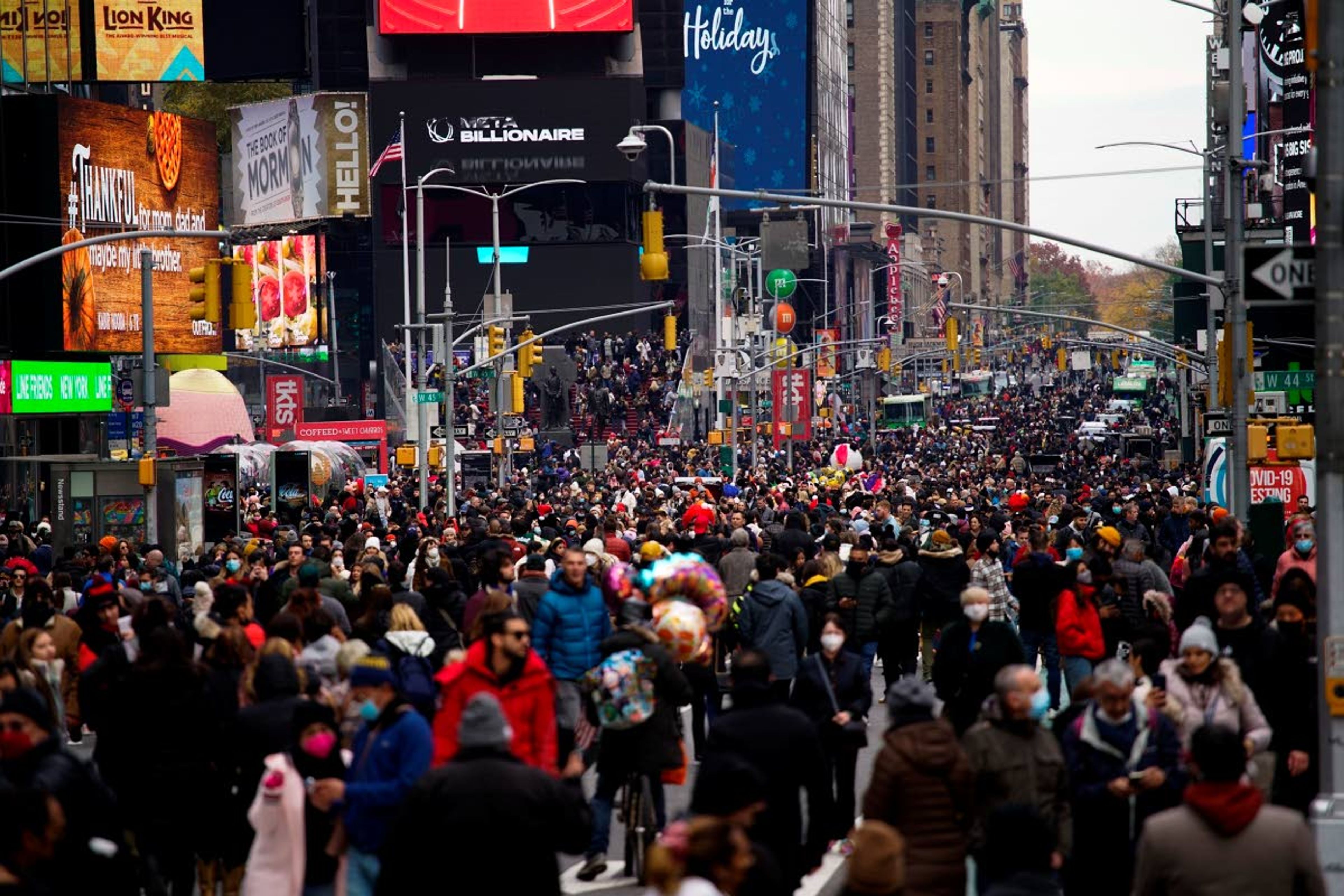 People make their way at Times Square after the Macy's Thanksgiving Day Parade, Thursday, Nov. 25, 2021, in New York. AP Photo/Eduardo Munoz Alvarez)