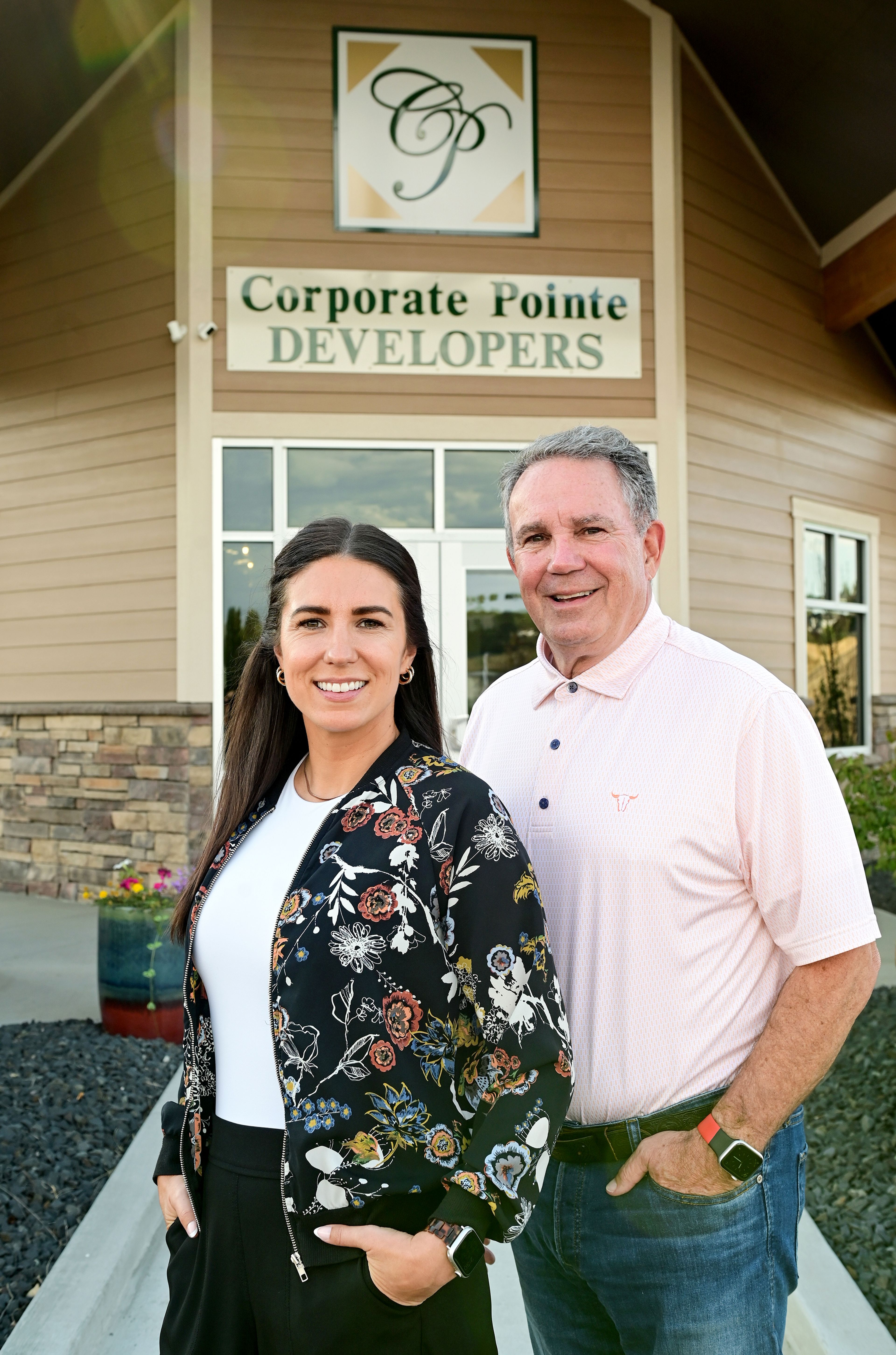 Nicole Morscheck, left, stands with her father, Duane Brelsford, outside of Corporate Pointe Developers in Pullman. Morscheck serves as the company's general manager, and is working to move into the role of president and managing member, a position her father has held at the company for decades.