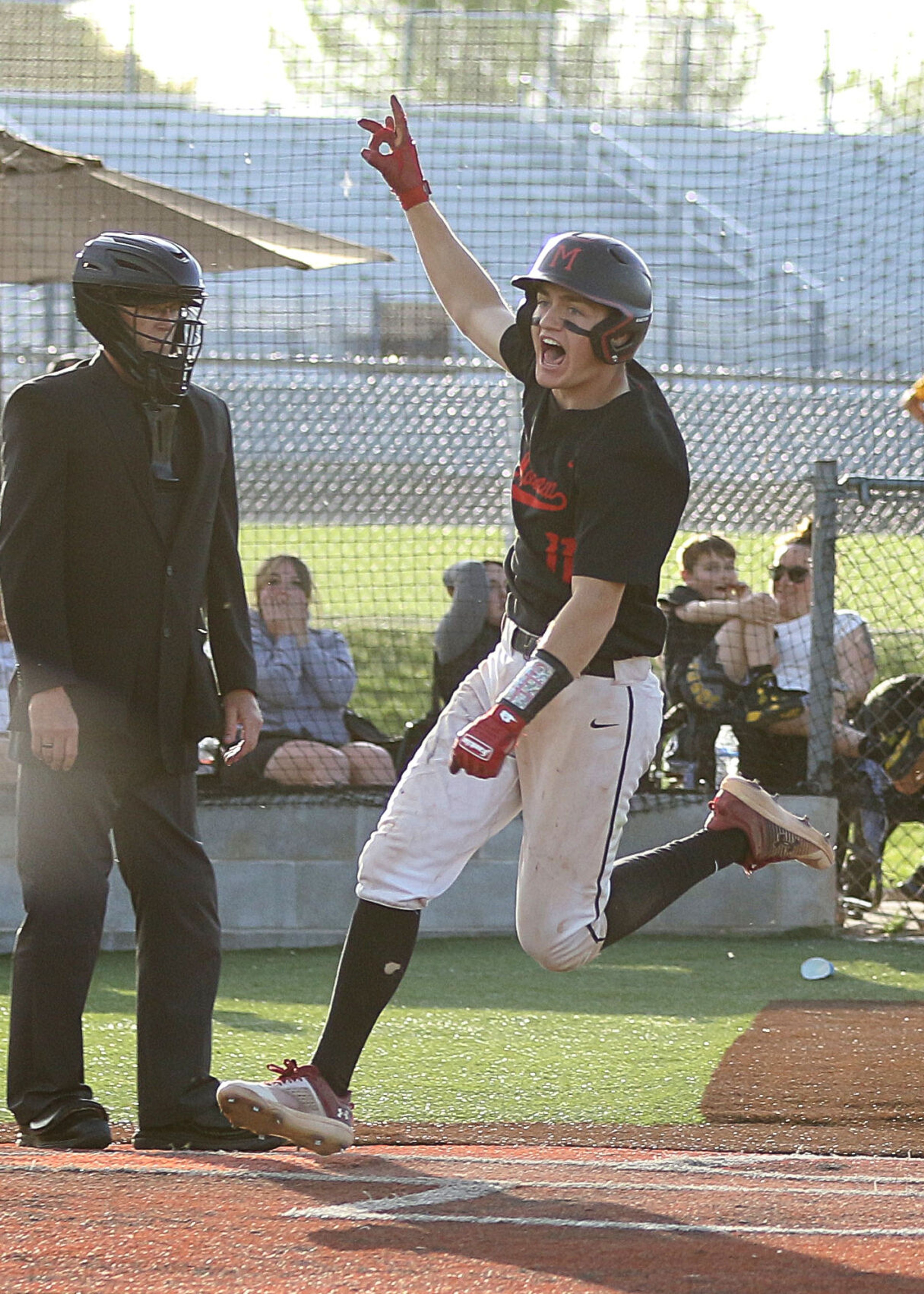 Moscow's Jack Driskill crosses home plate for the walk-off run against Bishop Kelly in the Idaho Class 4A state championship game on Saturday at Vallivue High School in Caldwell, Idaho.