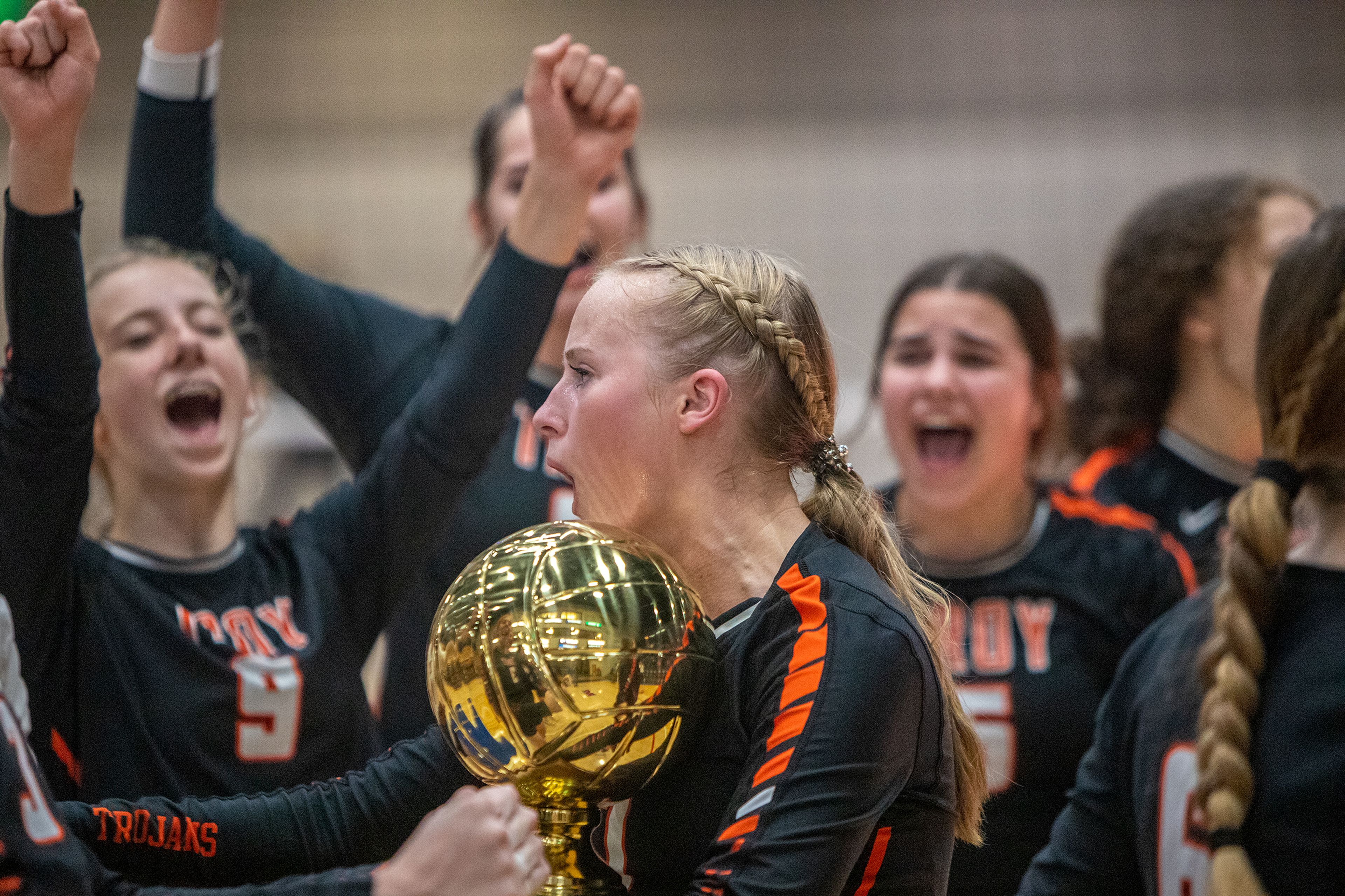 Troy High outside hitter Katie Gray holds teams trophy after defeating Genesee High in the Idaho Class 1A Division I district volleyball tournament at the P1FCU Activity Center in Lewiston on Wednesday.