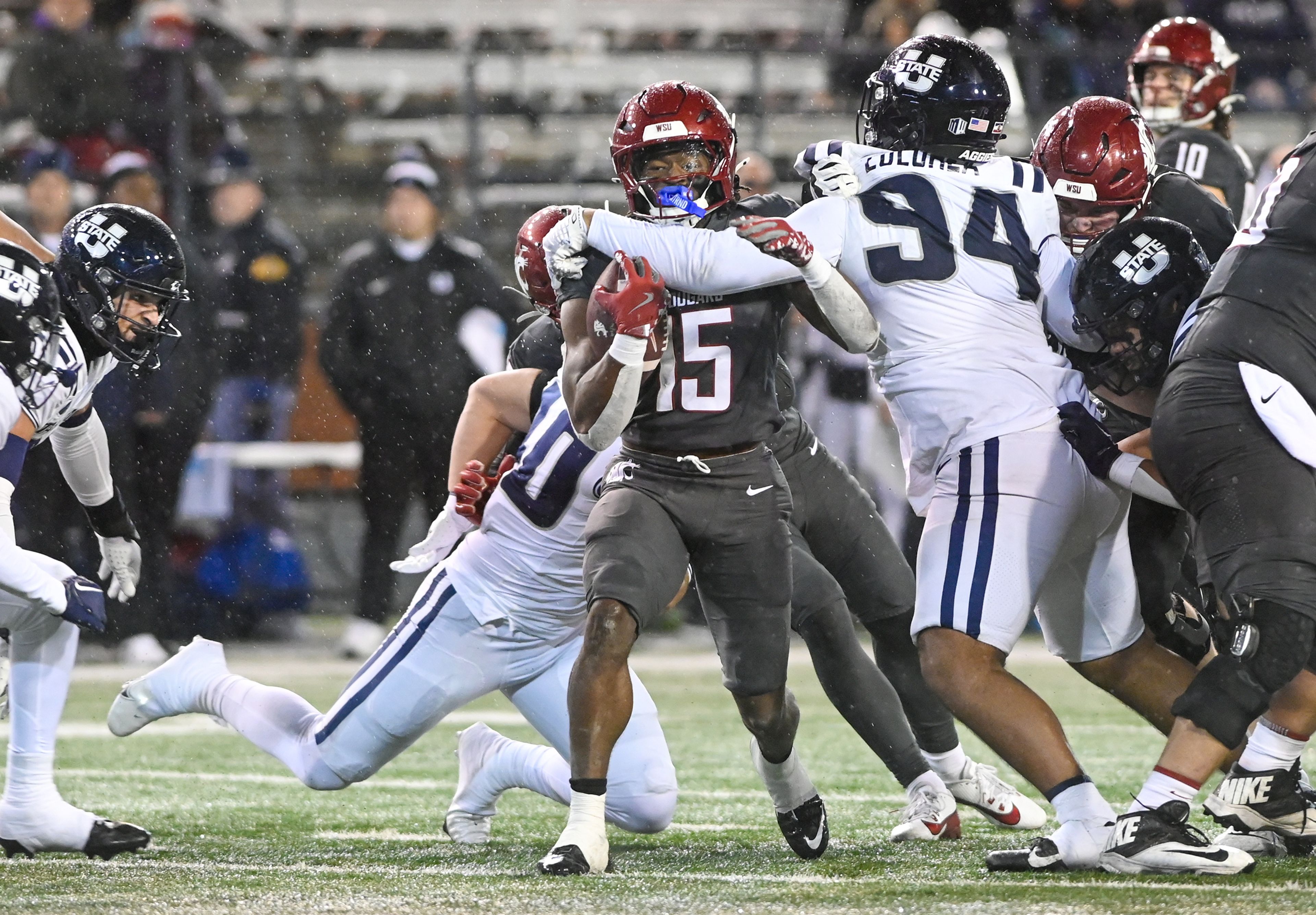 Washington State running back Djouvensky Schlenbaker (15) is blocked by Utah State defensive tackle Siolaa Lolohea (94) Saturday at Gesa Field in Pullman.