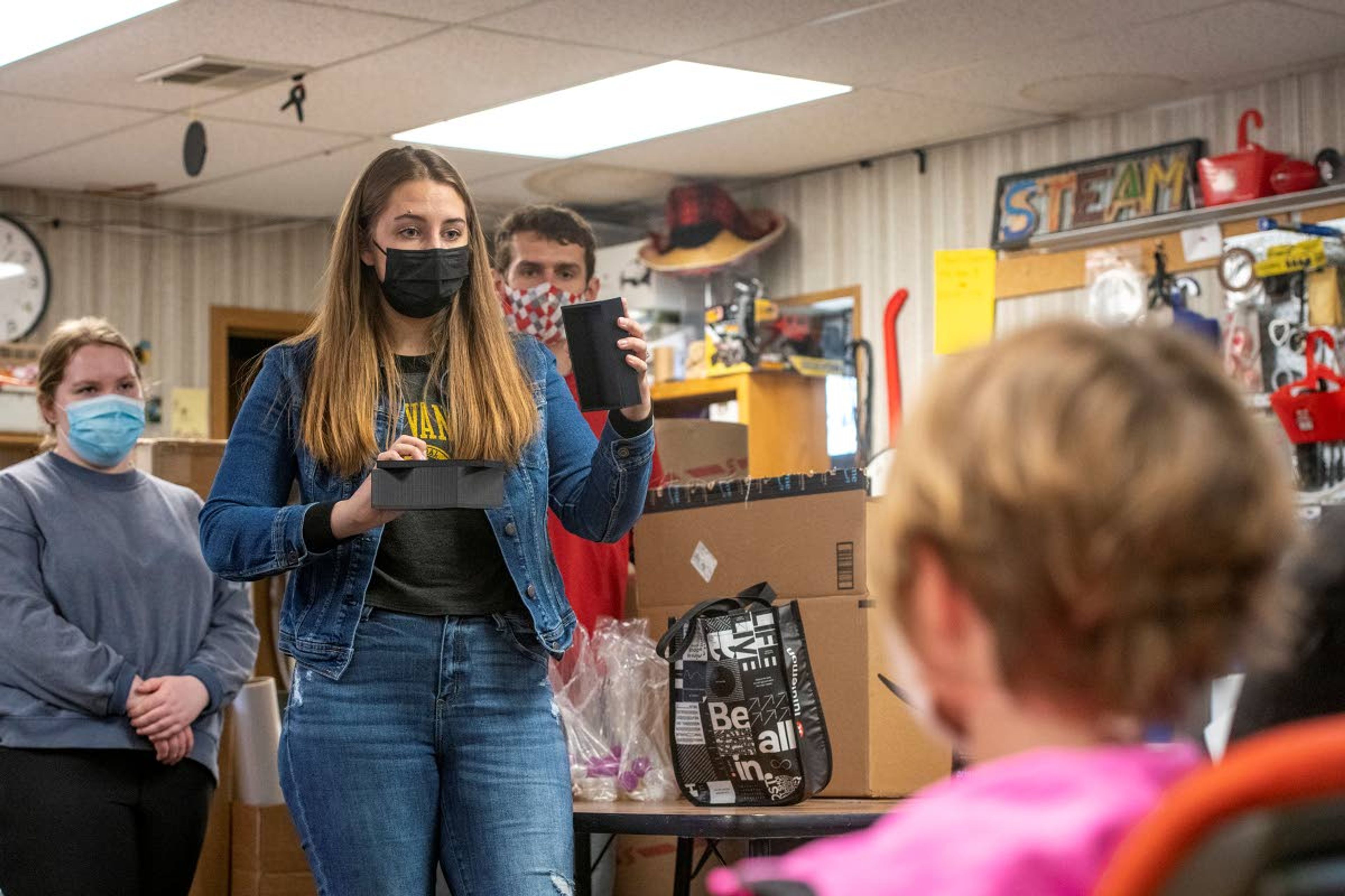 Hannah Johnson, a chemical engineering student at the University of Idaho, shows prototypes of nano-labs that are part of a collaborative experiment with NASA to students from Russell Elementary School in Moscow. The group of students from the university are part of a team called Vandal Voyagers 1.