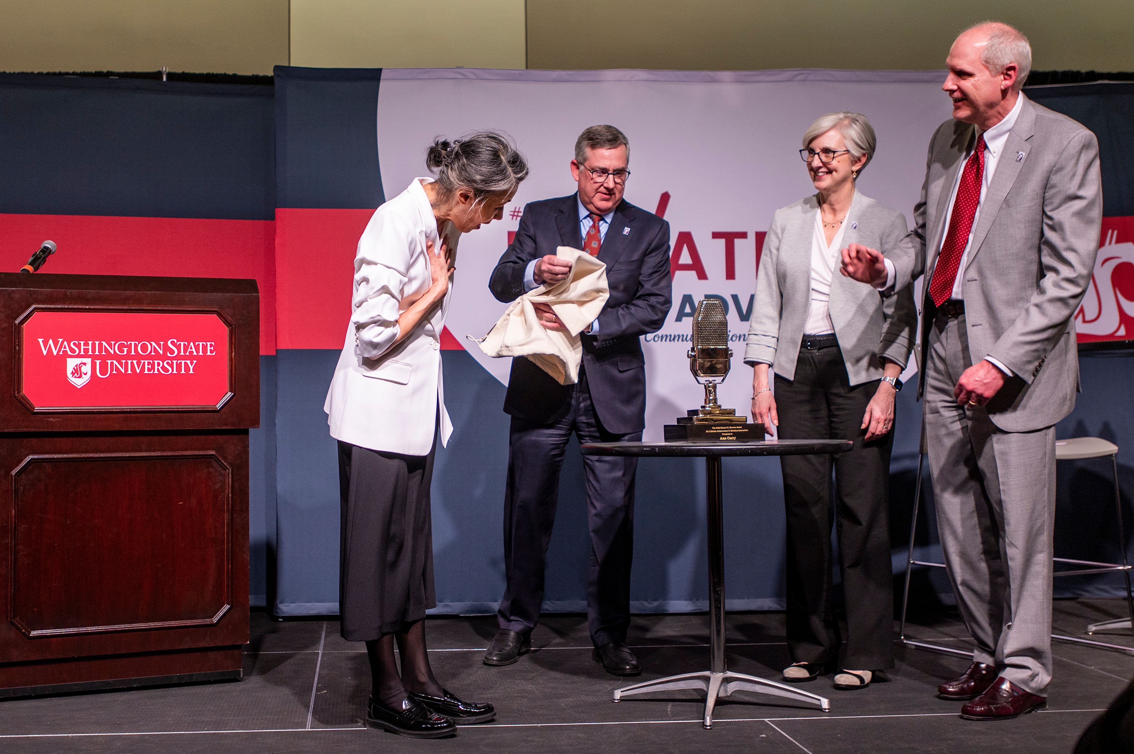 Washington State University President Kirk Schulz, center left, presents journalist Ann Curry, left, with the Murrow Lifetime Achievement Award in Broadcast Journalism on Tuesday at the 46th annual Murrow Symposium at WSU’s Compton Union Building in Pullman.