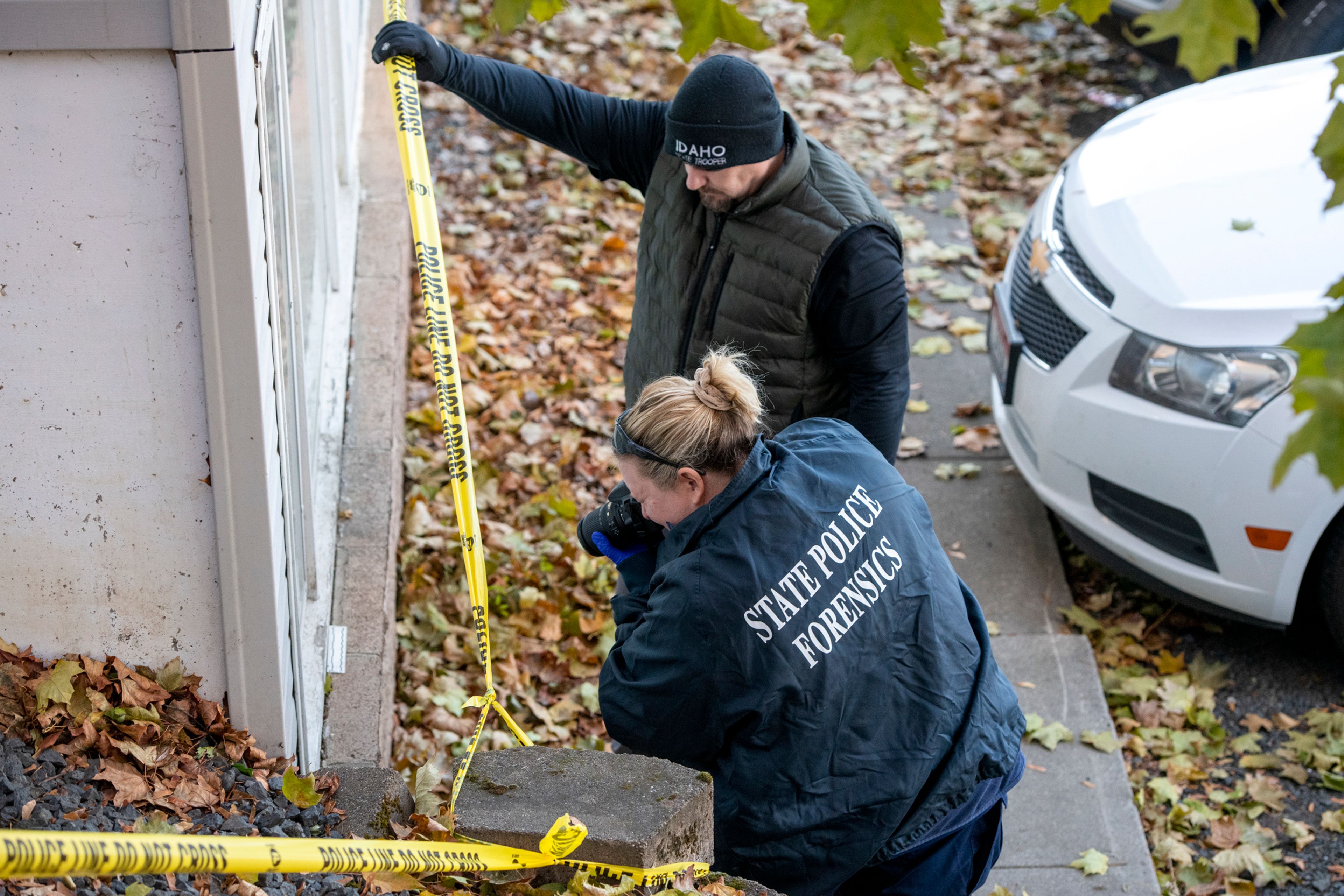 Members of the Idaho State Police forensic team investigate Friday at a home where four University of Idaho students were recently murdered over the weekend in Moscow.