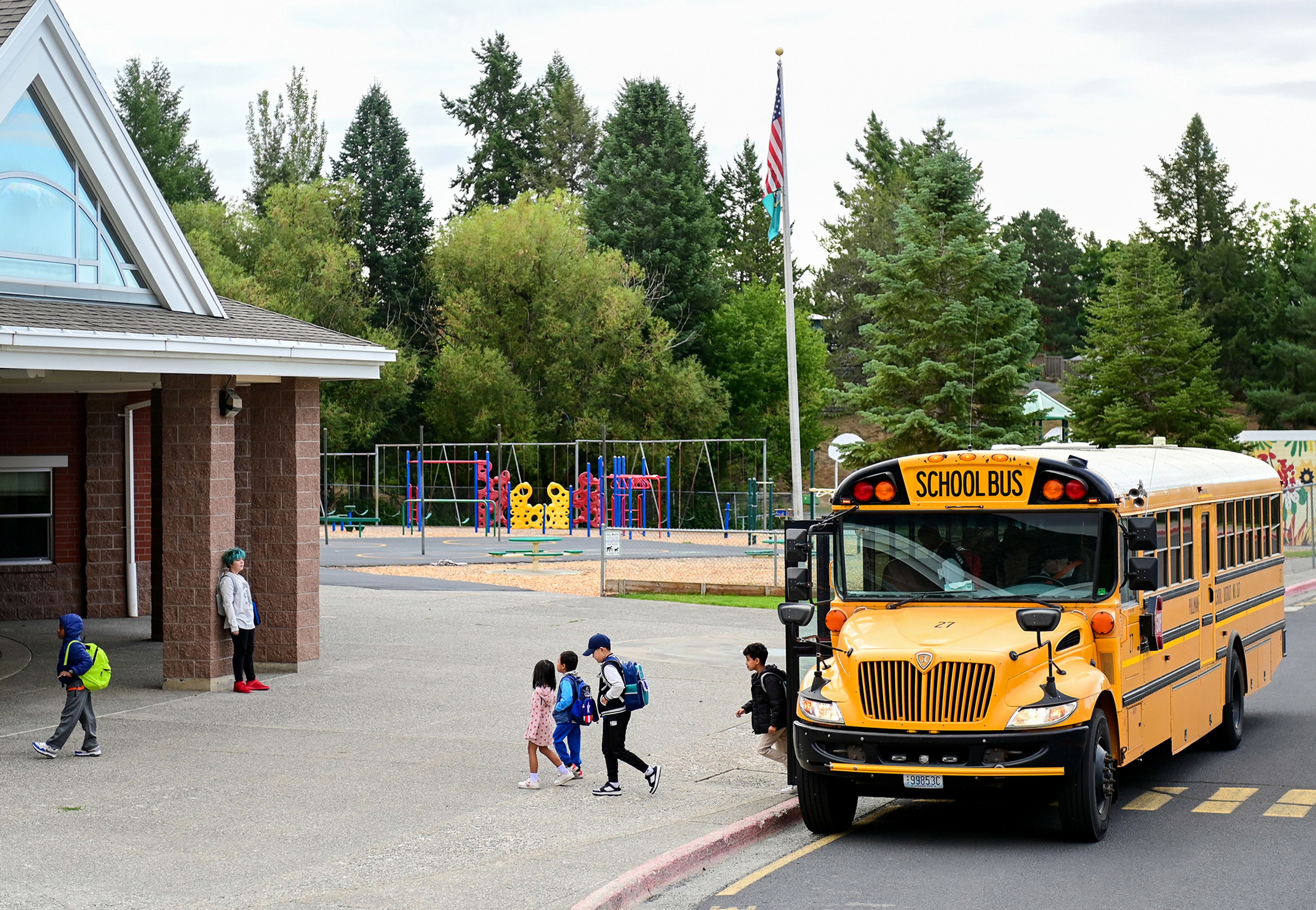 Students make their way off the bus to Jefferson Elementary School for their first day of school on Wednesday in Pullman.