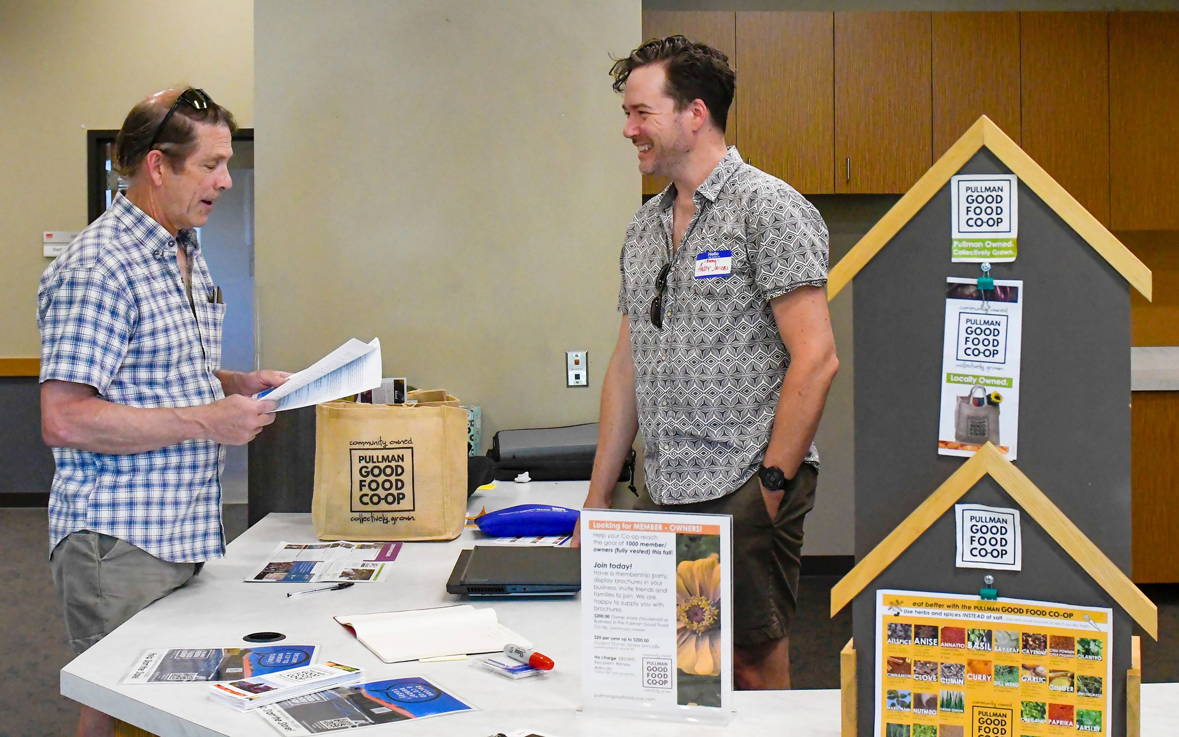 Bill Brock, left, of Pullman, speaks with Pullman Good Food Co-op upcoming board of directors chair, on Wednesday at the co-op’s open house in Pullman.