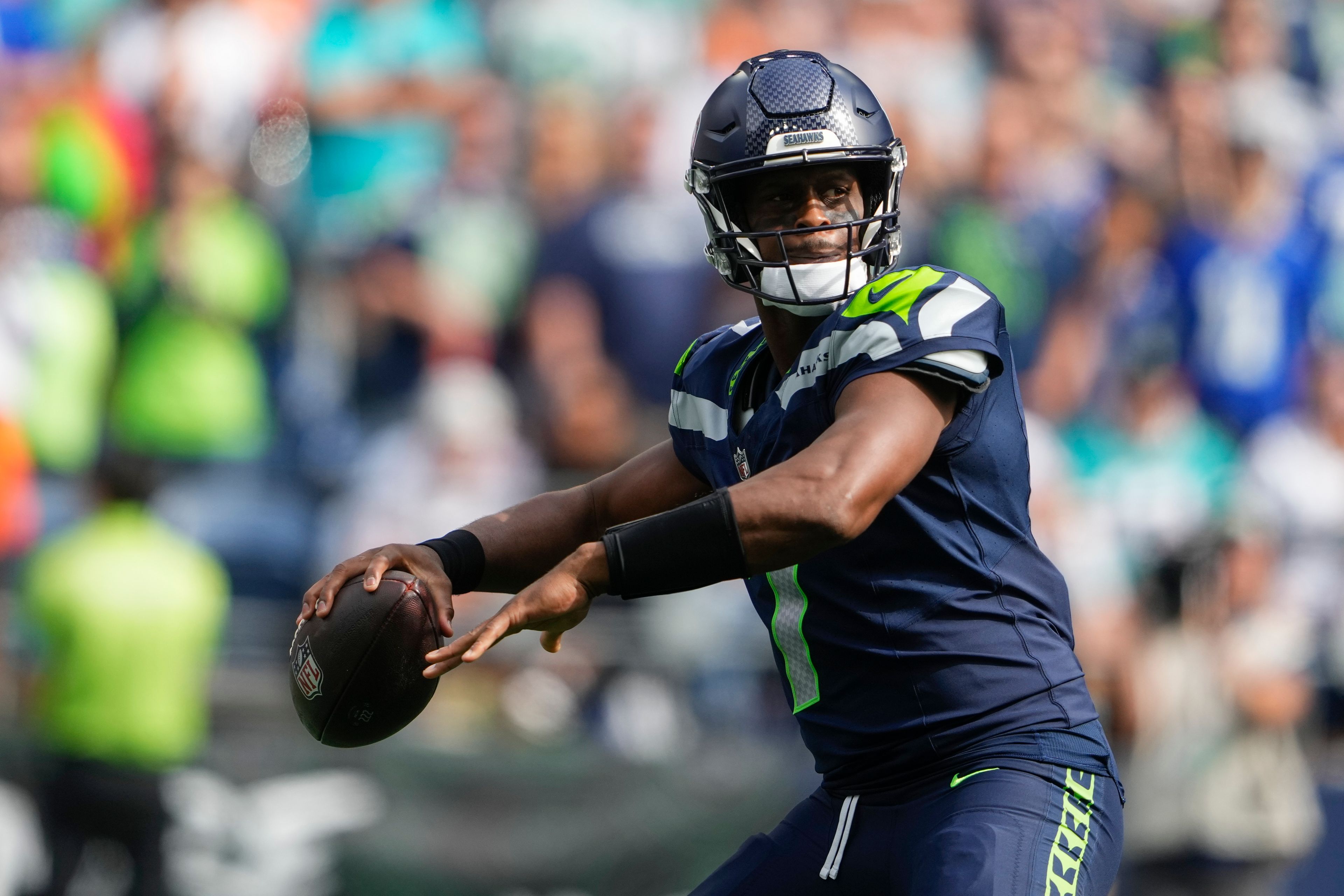 Seattle Seahawks quarterback Geno Smith looks to throw during the first half of an NFL football game against the Miami Dolphins, Sunday, Sept. 22, 2024, in Seattle. (AP Photo/Lindsey Wasson)