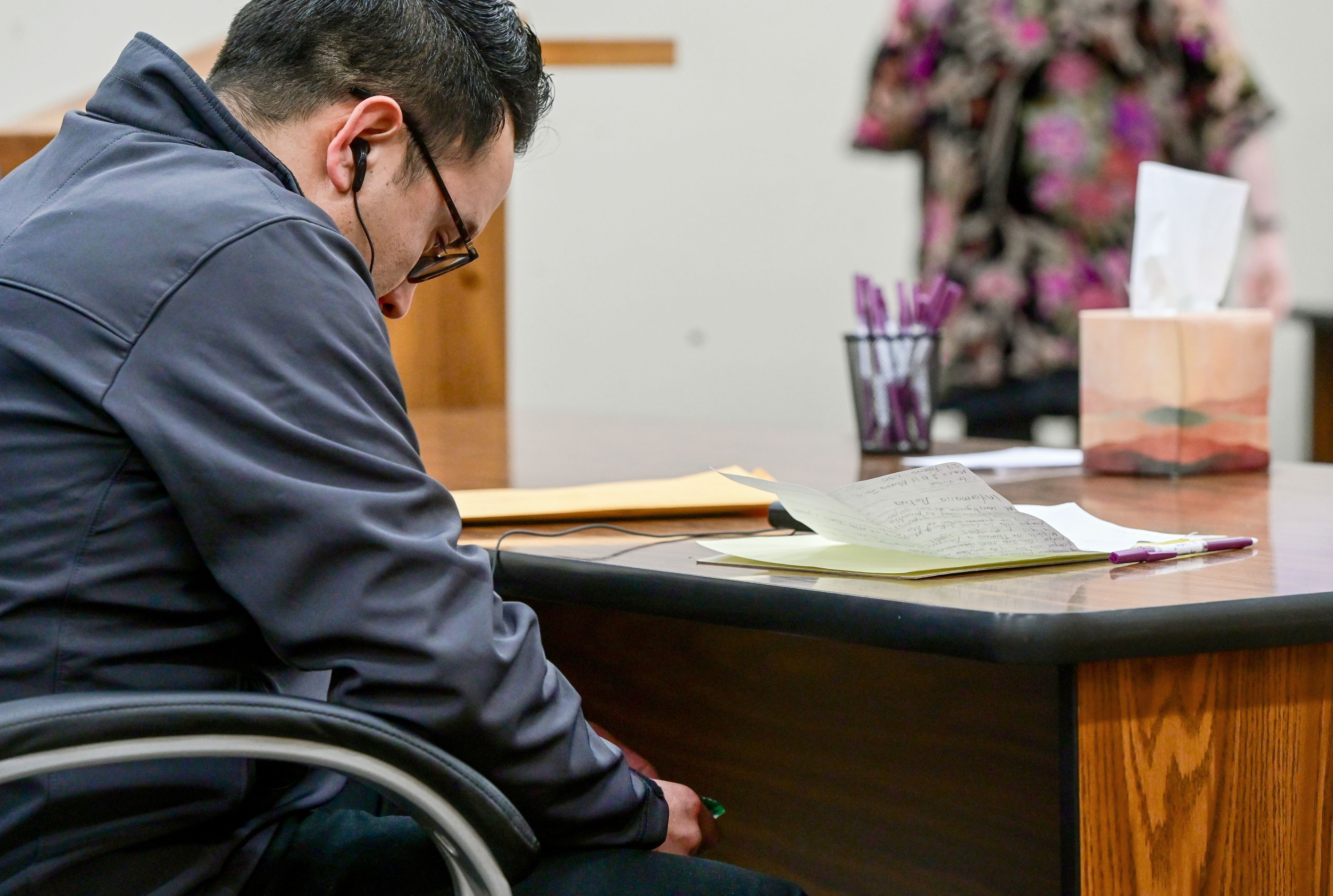 Juan Trejo Perez looks down at photos in his hands while waiting for a verdict in the felony third-degree child molestation trial in Colfax on Wednesday. Trejo Perez was found guilty by a jury, and will be sentenced at a later date.