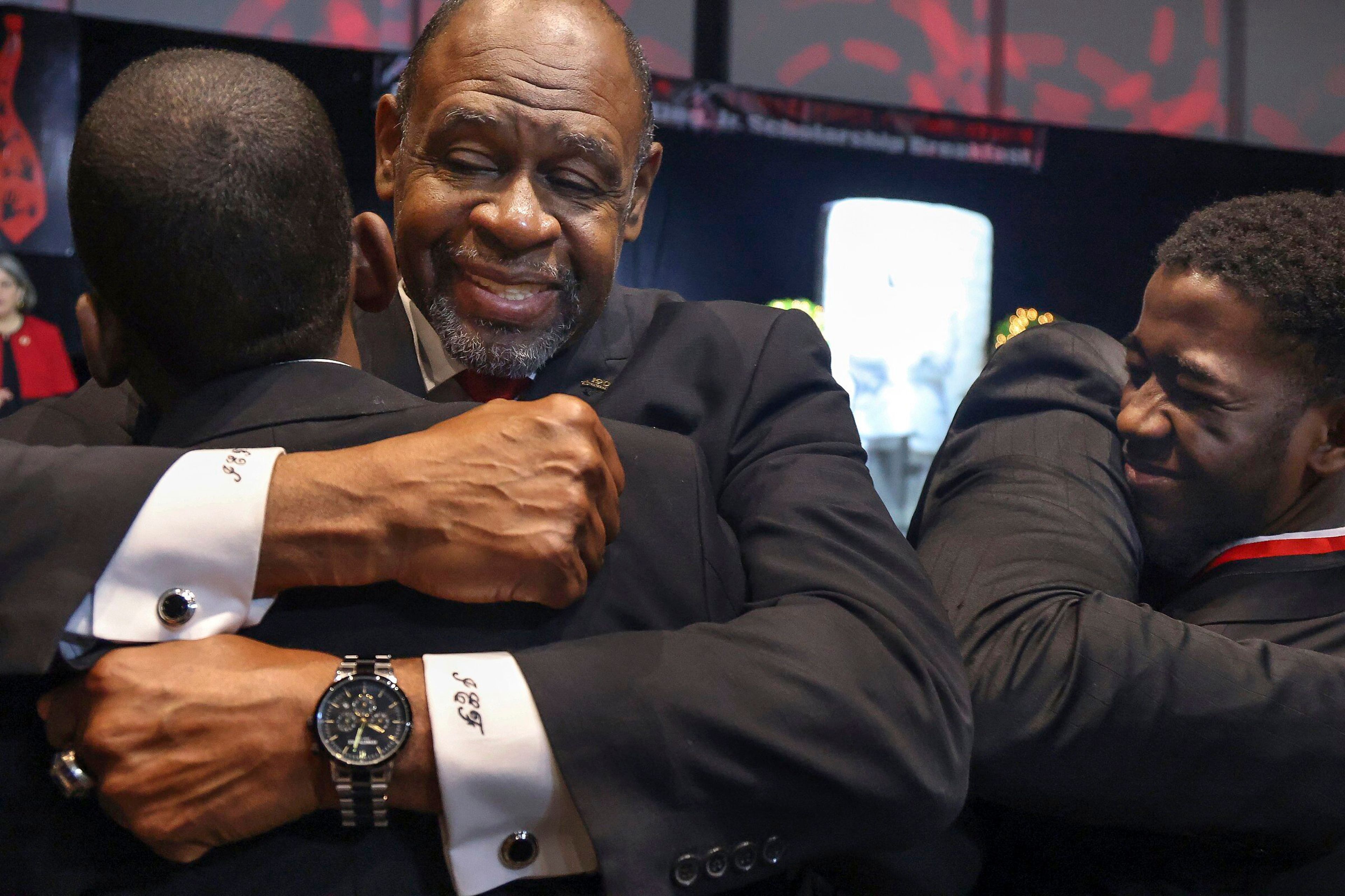 Miami-Dade Public schools educator Ira Fluitt, center, embraces student Andre Jackson, right, after being recognized as one of the 49 Wilson Scholars for Class of 2023, during the Annual Dr. Martin Luther King, Jr. Scholarship Breakfast on Monday, Jan. 16, 2023, at the Miami Beach Convention Center. The 5000 Role Models of Excellence Project celebrated its 30th Anniversary with a keynote address by Douglas Emhoff, the second gentleman of the U.S., who is married to the first female vice president, as the organization honored 2023 Wilson Scholars, Philanthropic Mentors, and inducted Models of Excellence. (Carl Juste/Miami Herald via AP)