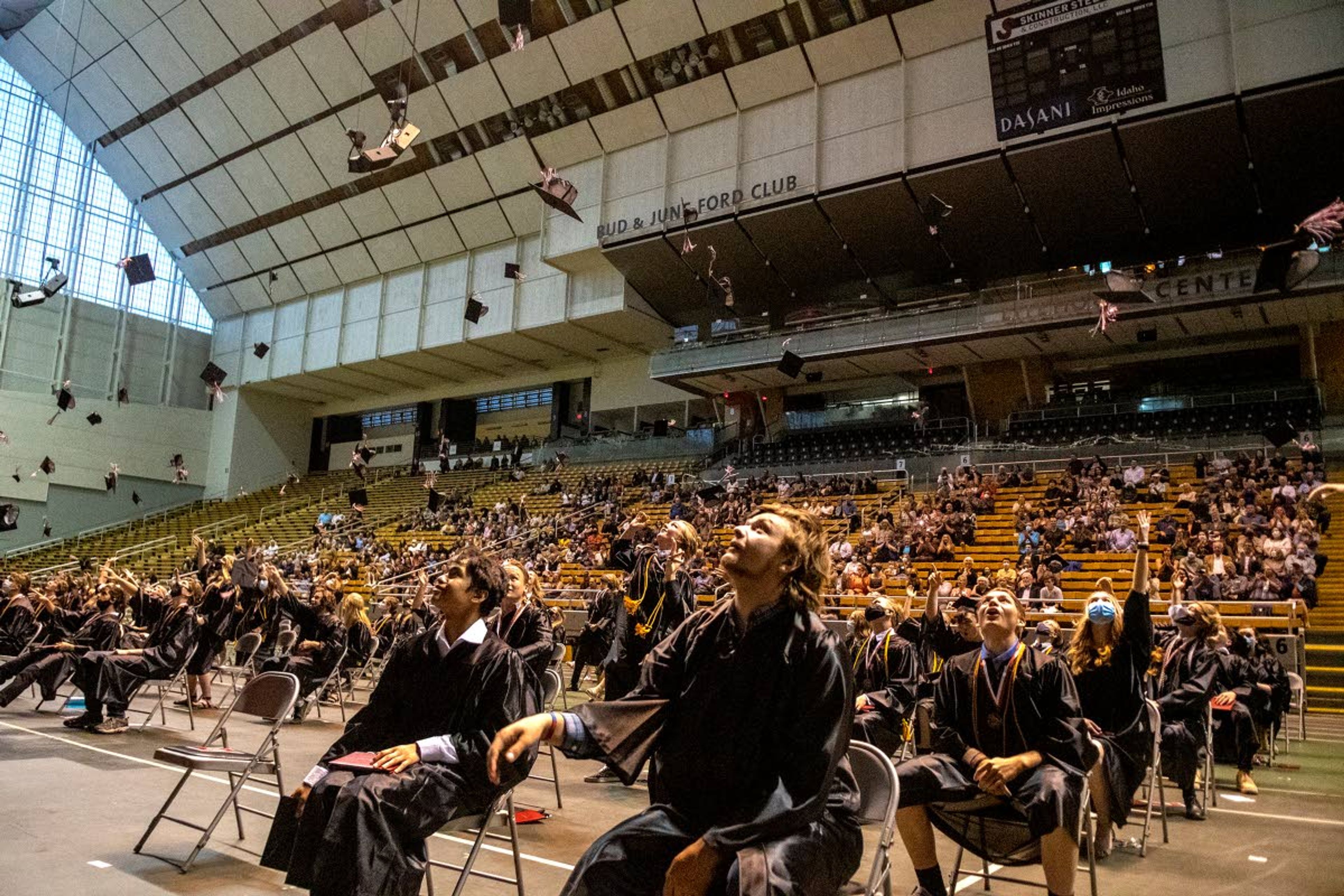 Moscow High School graduating seniors toss their caps into the air at the end of their commencement at the University of Idaho’s Kibbie Dome on Friday night.