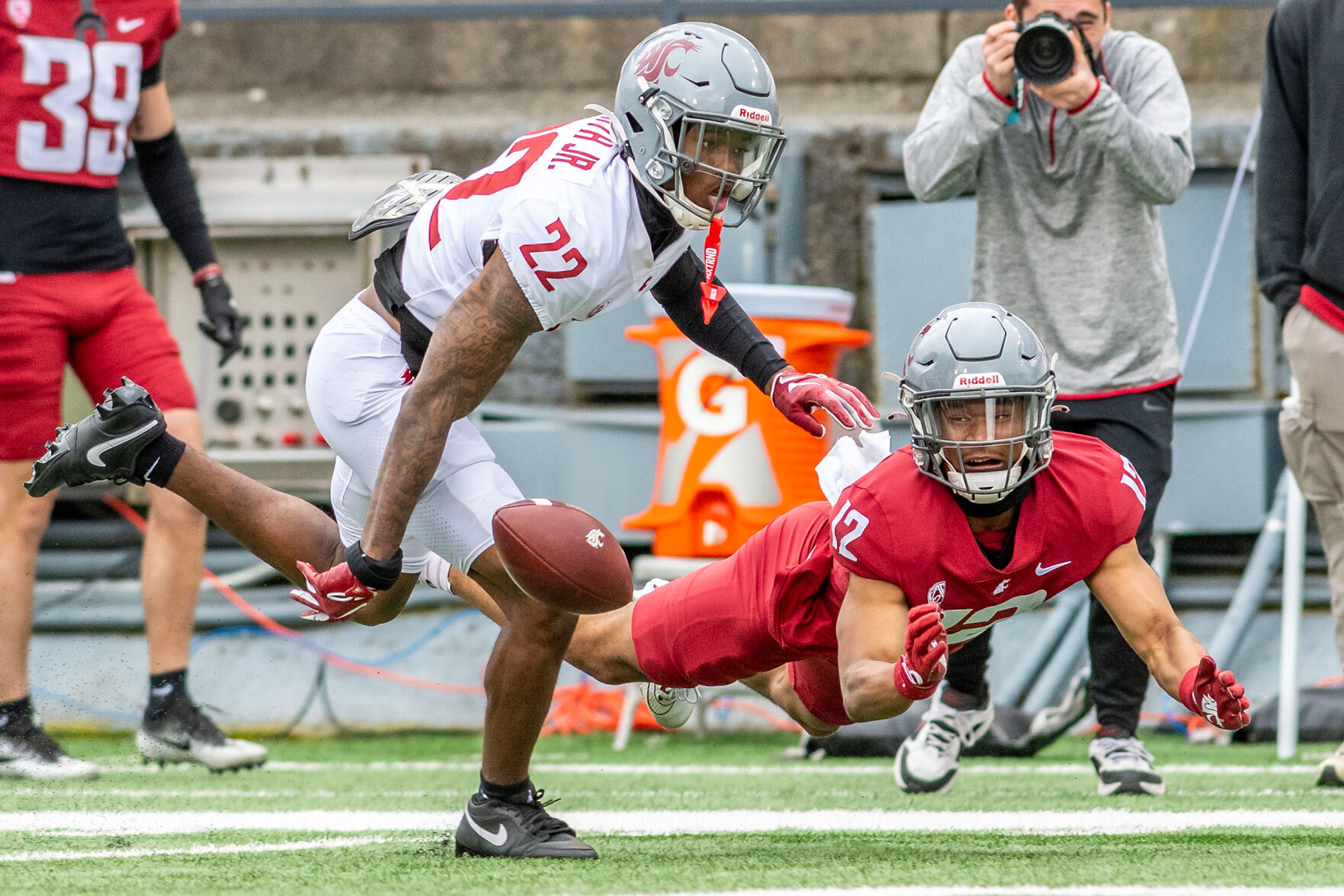 Crimson wide receiver Leon Neal Jr. and Gray defensive back Warren Smith Jr. watch the ball hit the ground on a missed catch in a quarter of the Crimson and Gray Game at Washington State University in Pullman.