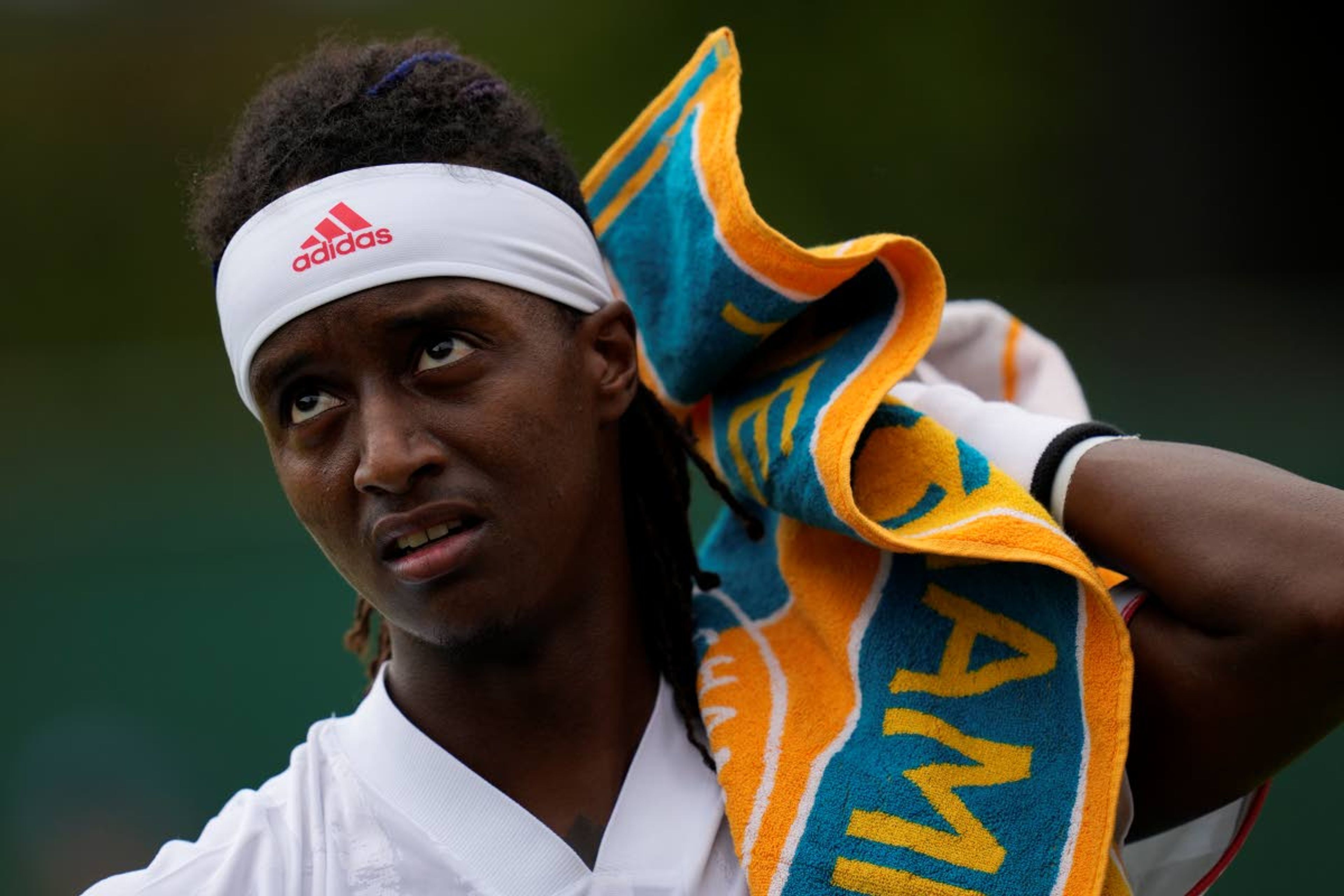 Sweden's Mikael Ymer uses a towel during the men's singles first round match against Jo-Wilfried Tsonga of France on day three of the Wimbledon Tennis Championships in London, Wednesday June 30, 2021. (AP Photo/Kirsty Wigglesworth)