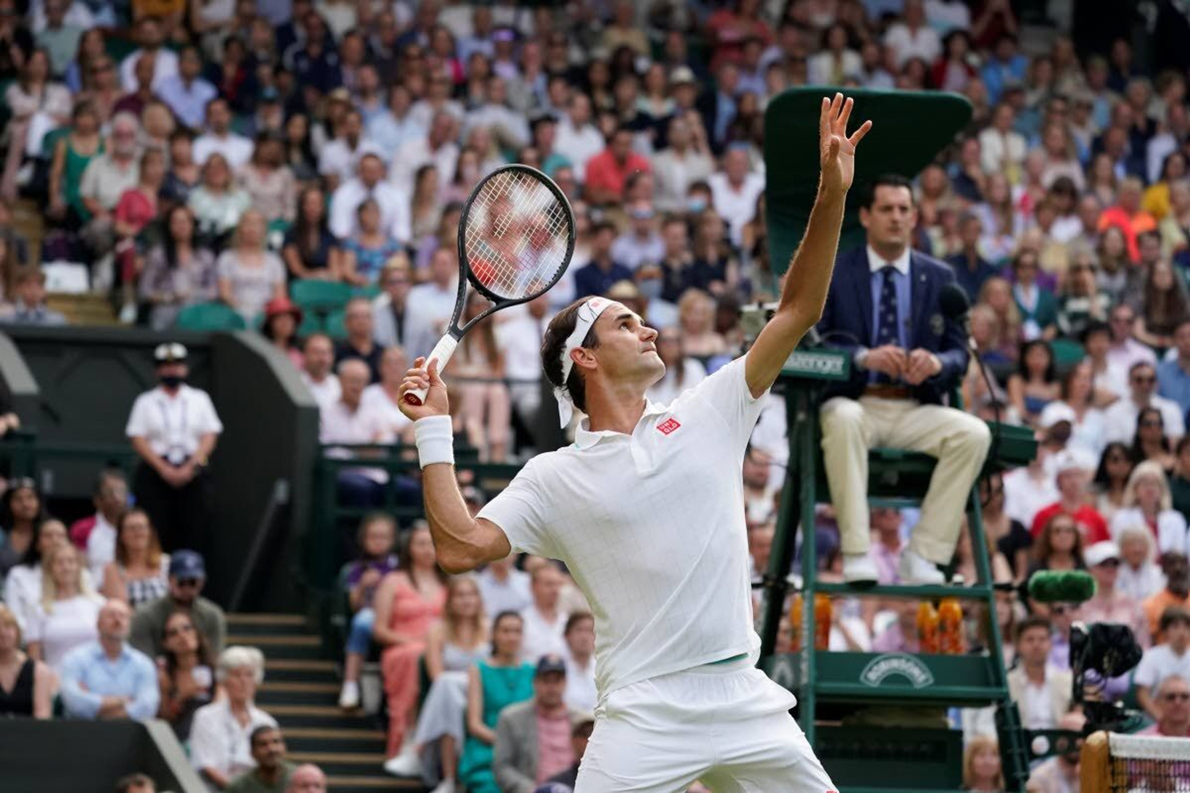 Switzerland's Roger Federer serves to Richard Gasquet of France during the men's singles second round match on day four of the Wimbledon Tennis Championships in London, Thursday July 1, 2021. (AP Photo/Alberto Pezzali)